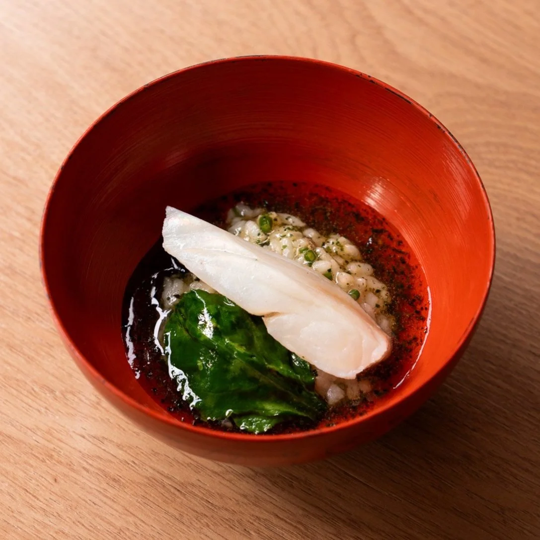 Sake Kasu & Anchovy Marinated Turbot Risotto at TAKU: A sustainable dish made with sake kasu-marinated turbot, crispy burnt sushi rice, pickled shallots, myoga, smoked eel, and rich mussel stock