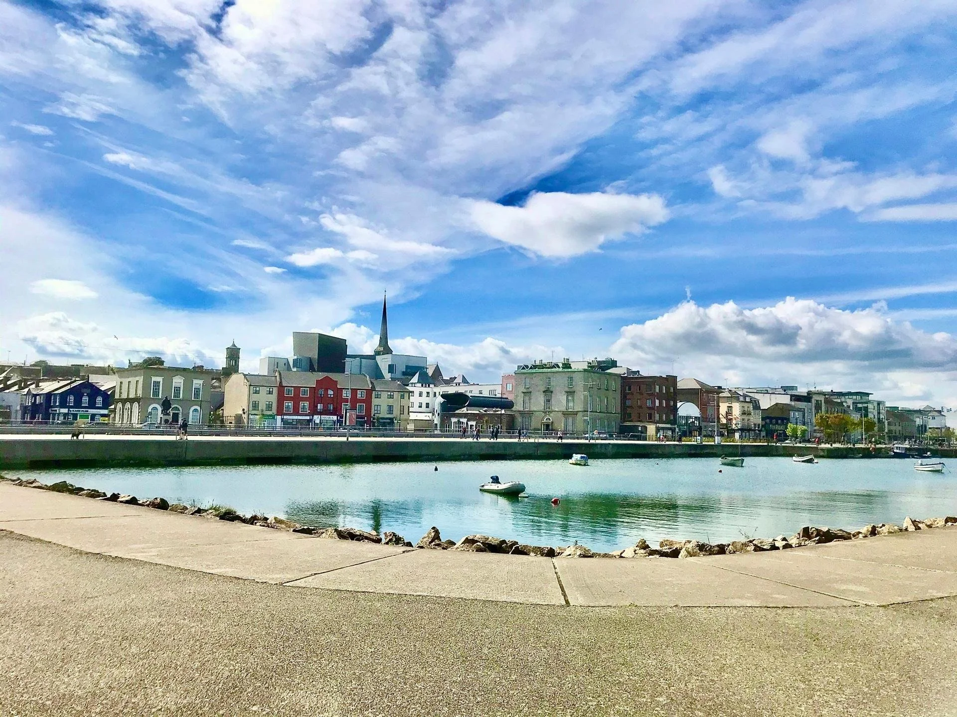 wexford dock on a sunny day, in the background are colourful buildings lining the street 