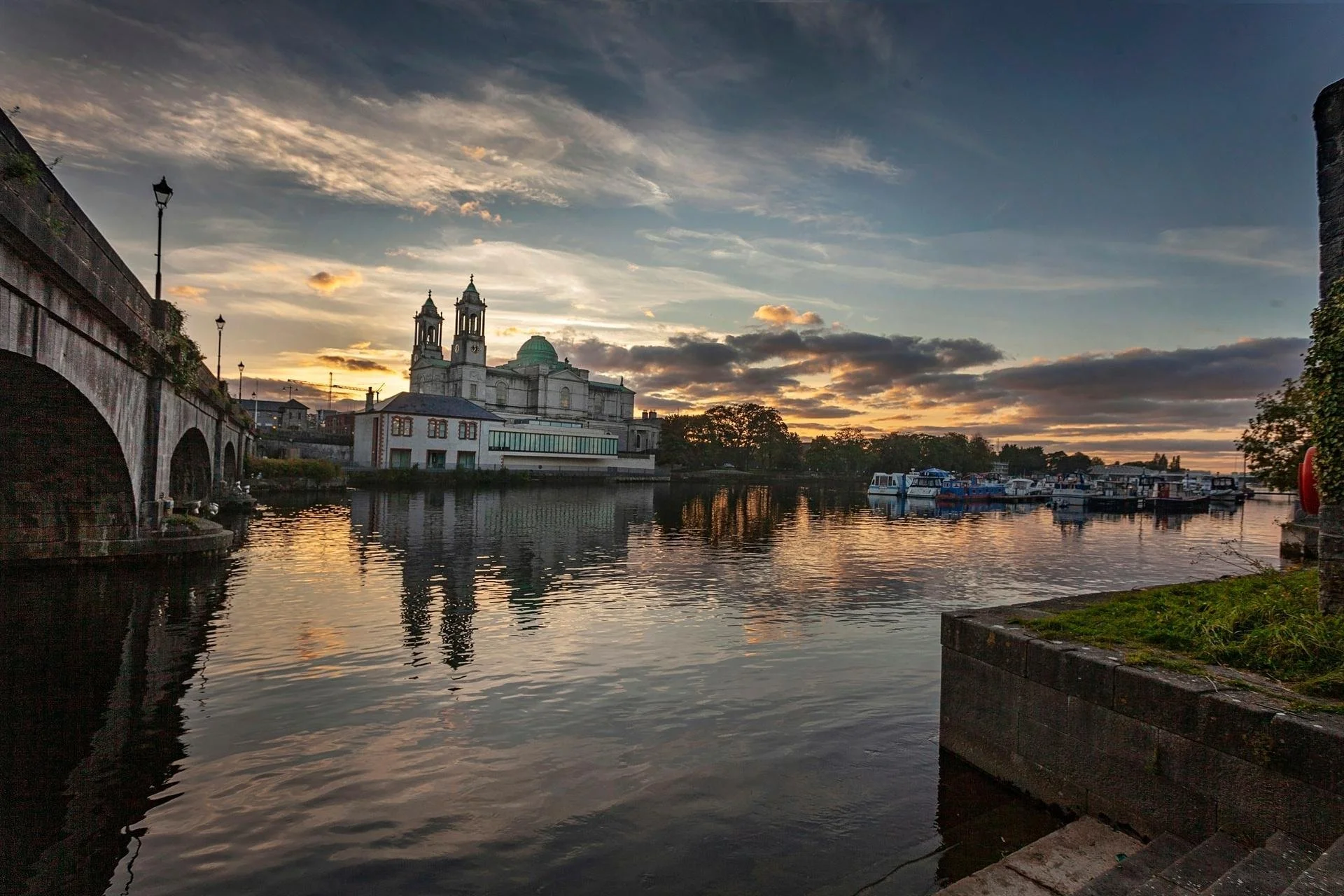 view of the shannon river from athlone looking onto a church and the army barracks