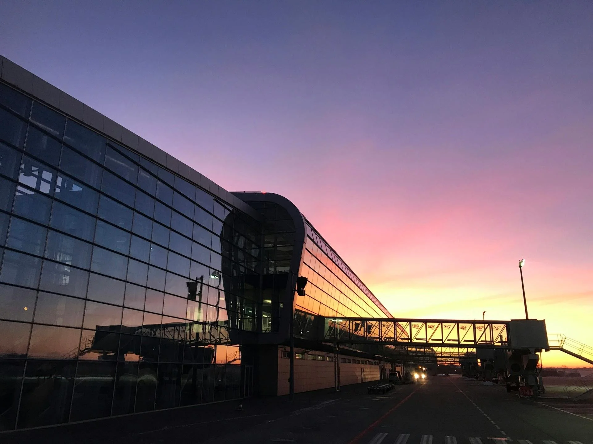 dublin airport at sunset with a purple, pink, orange, and yellow sky