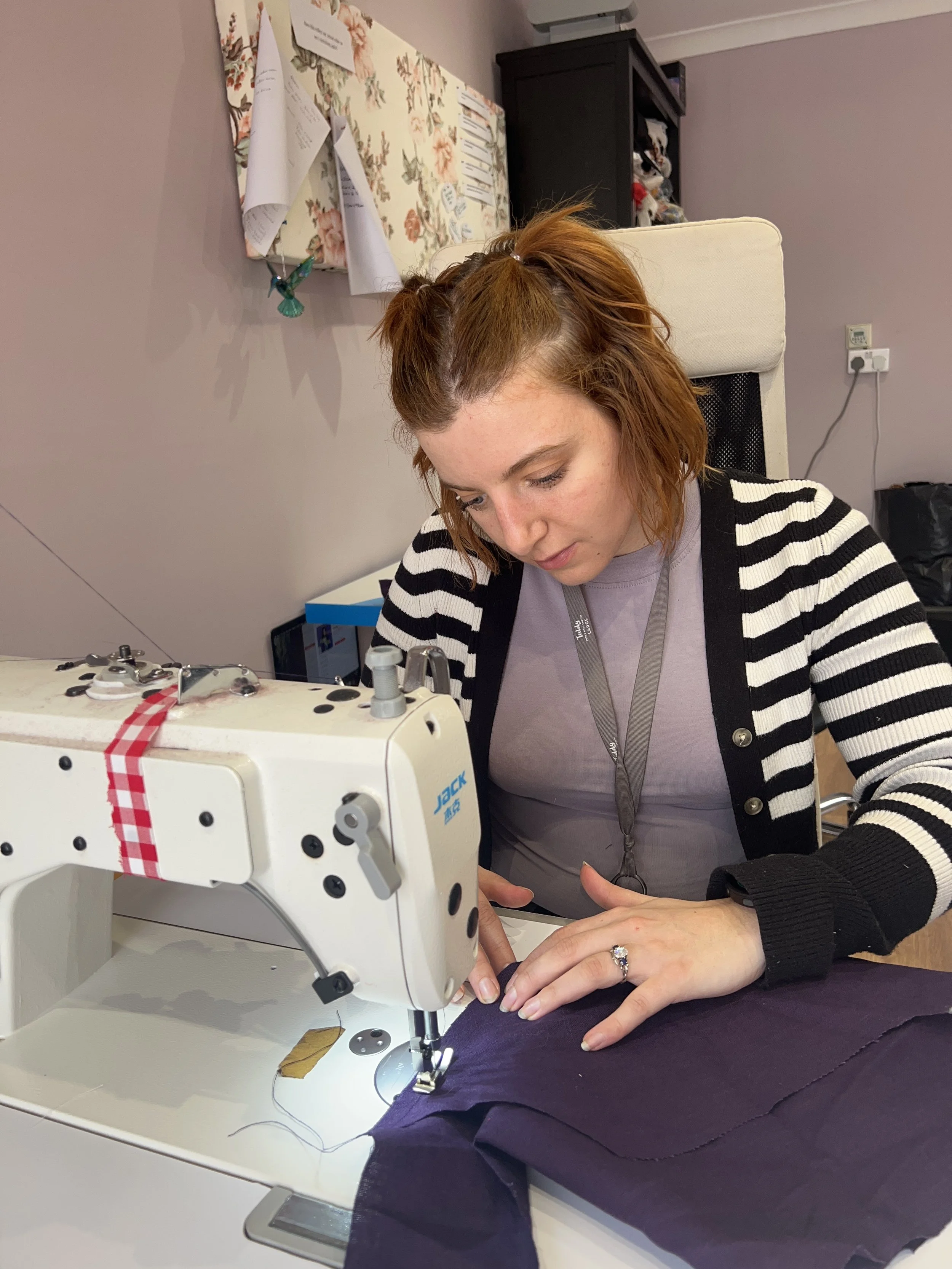 artisan stitcher and upcycler Ellie sat at her industrial sewing machine