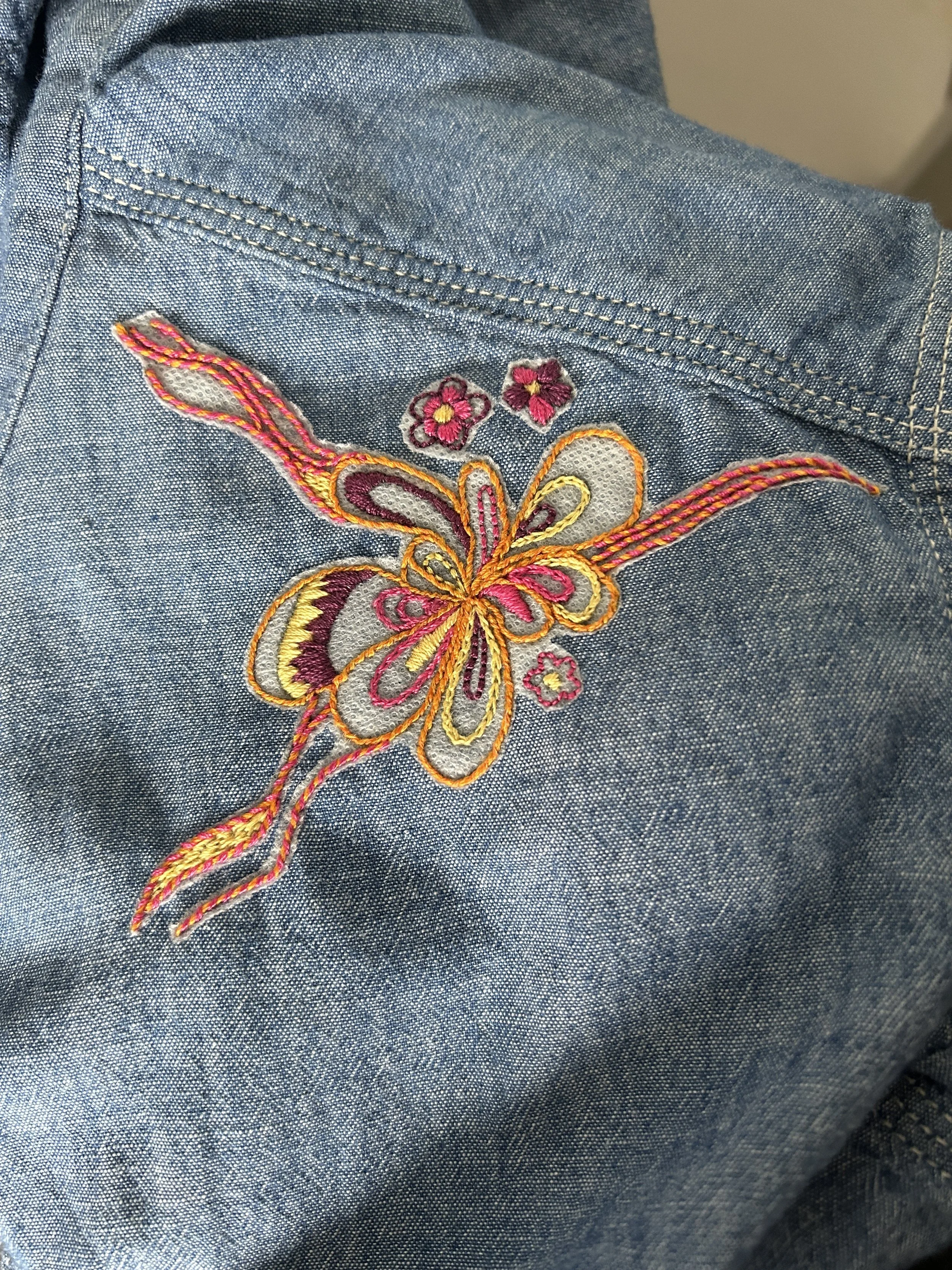 hand embroidered flower motif on upcycled chambray shirt