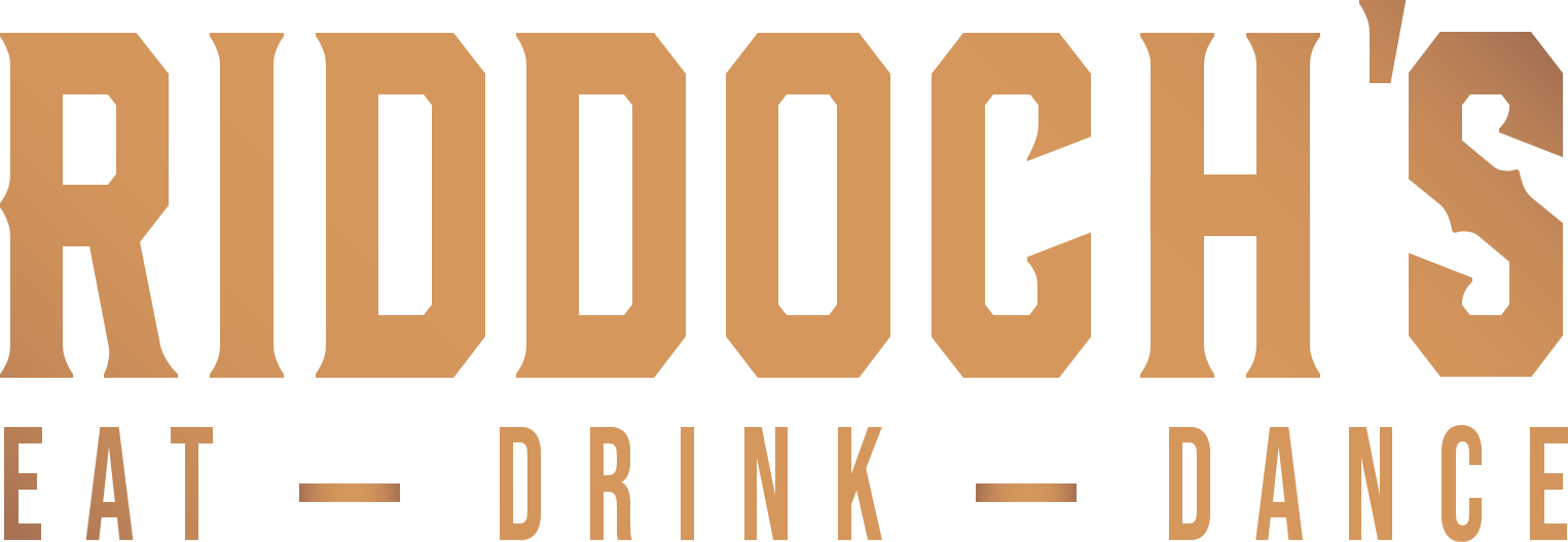 A close-up image of a brown board game with rectangular tiles, some of which have colored sections and text, set on a wood surface.