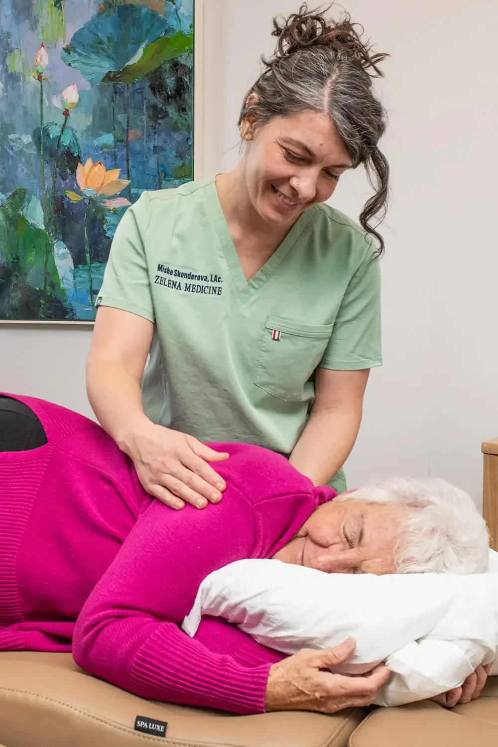 Mishe Skenderova, acupuncturist at Zelena Medicine in Basalt, Colorado doing treatment on older woman.
