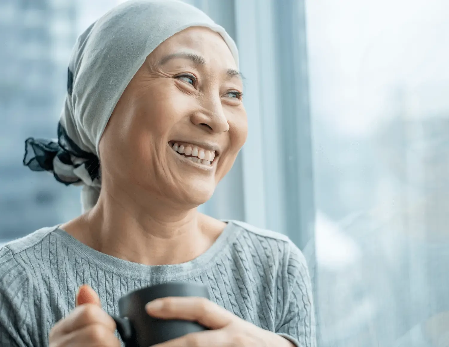 Smiling elderly cancer patient feeling strong after chemotherapy symptom support in Basalt, Colorado.