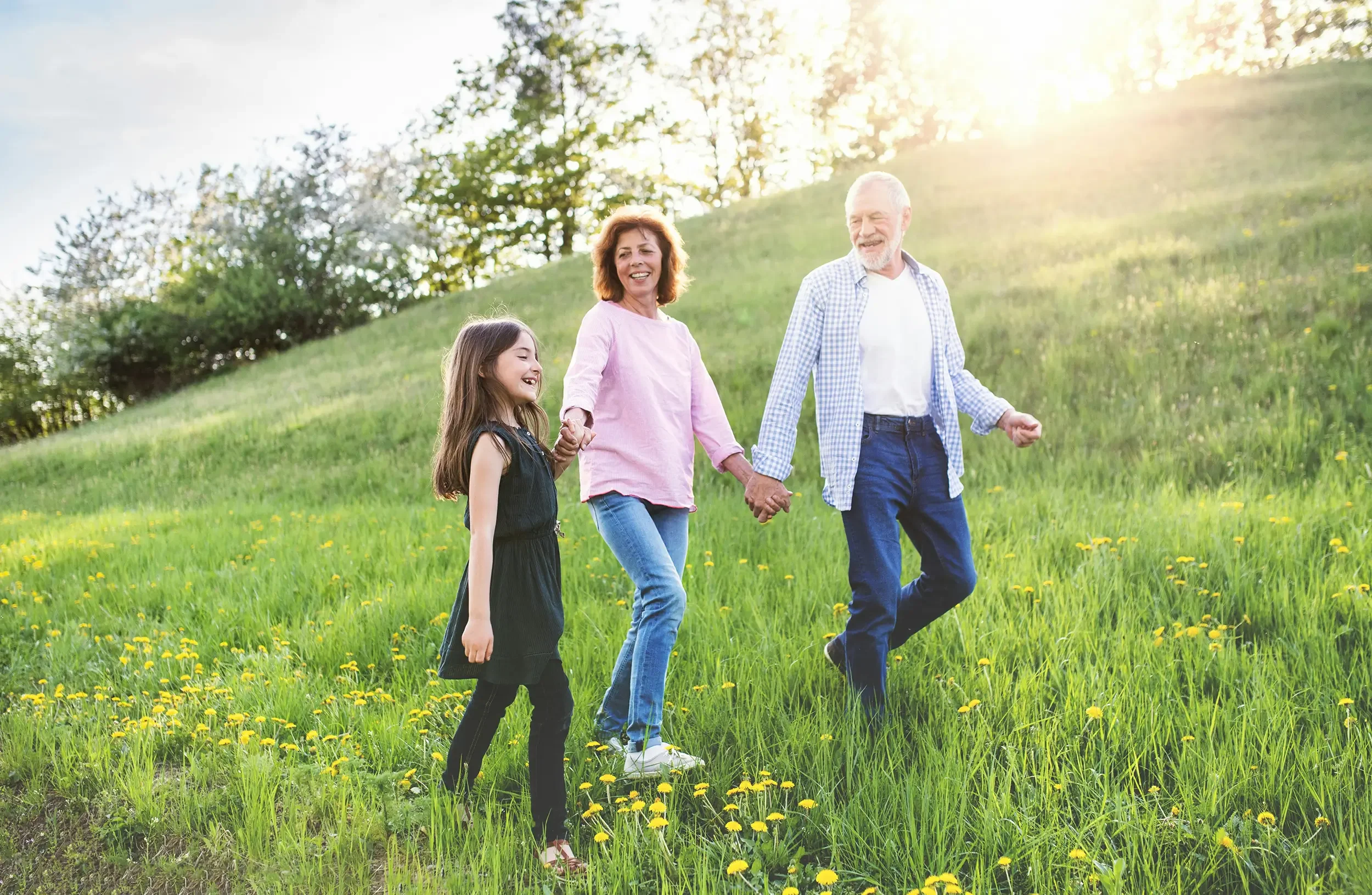 A multigenerational family walking hand in hand in Colorado after acupuncture and functional medicine for chronic pain.