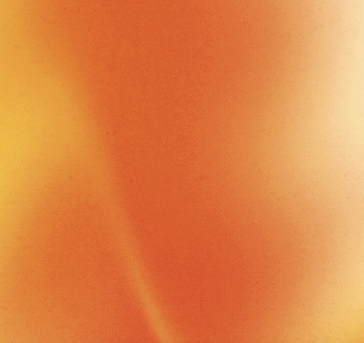 Close-up of orange fabric with subtle shading and texture.