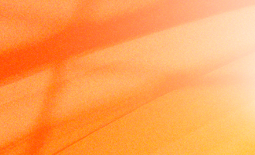 Close-up of an orange wooden surface with light reflections.