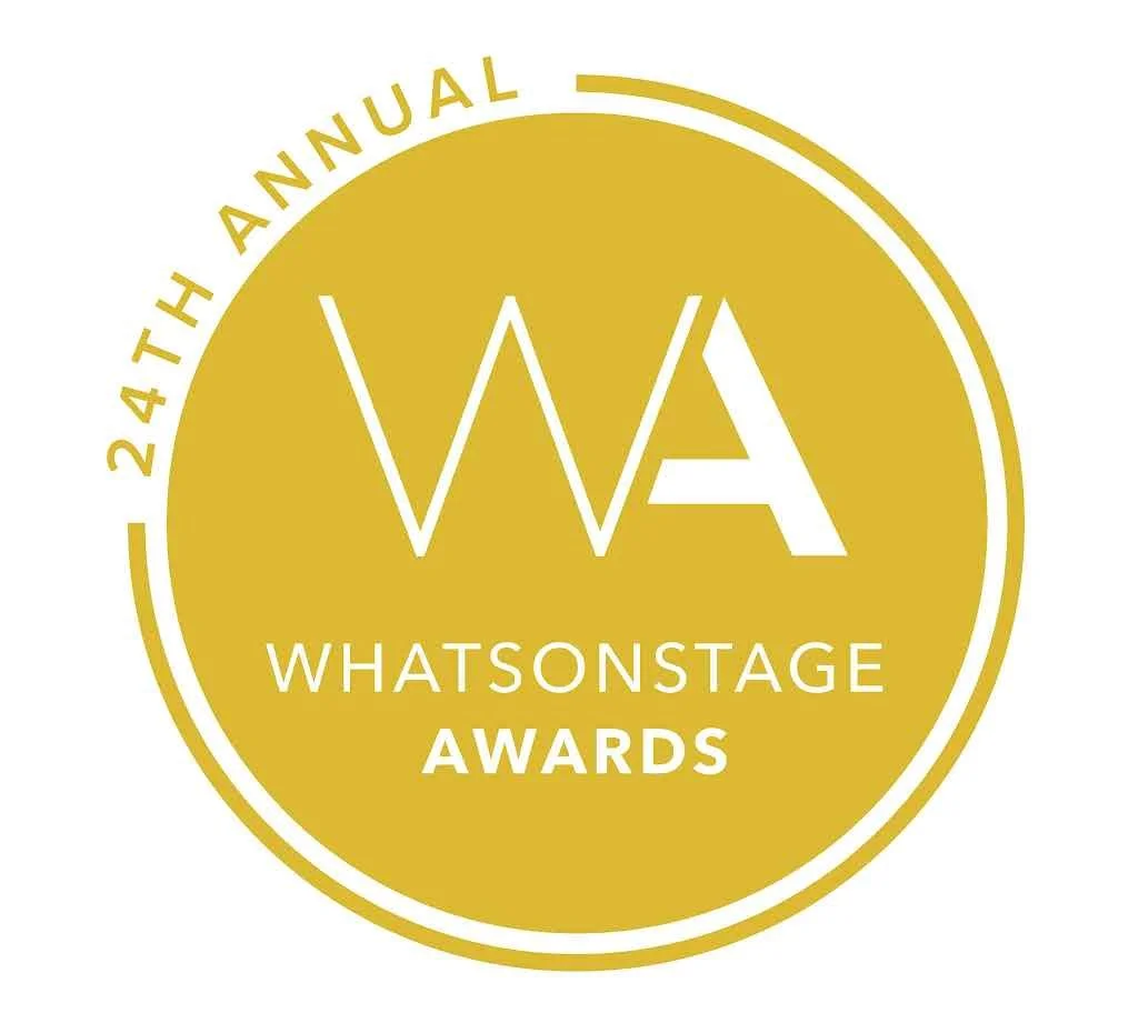 A gold circular logo for the 24th Annual Whatsonstage Awards, with the text "WA" in large white letters in the center, and "WHATSONSTAGE AWARDS" below it. The outer ring of the circle has the text "24TH ANNUAL".