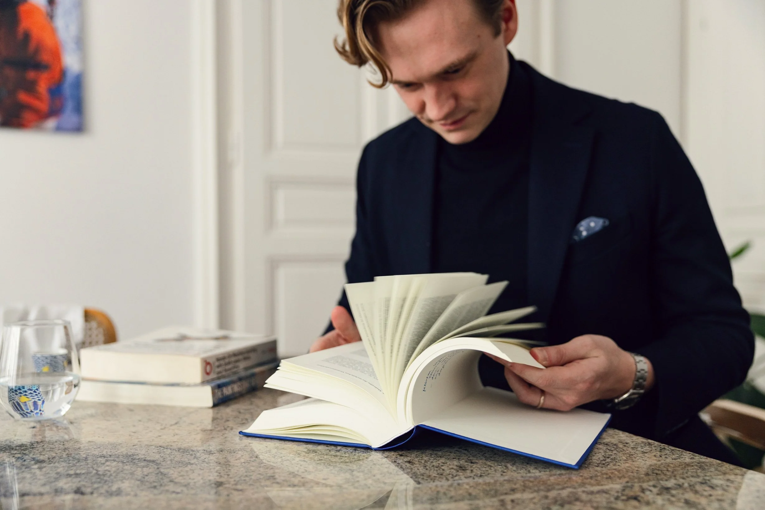 Dominik Loidl reading a law book sitting at a table
