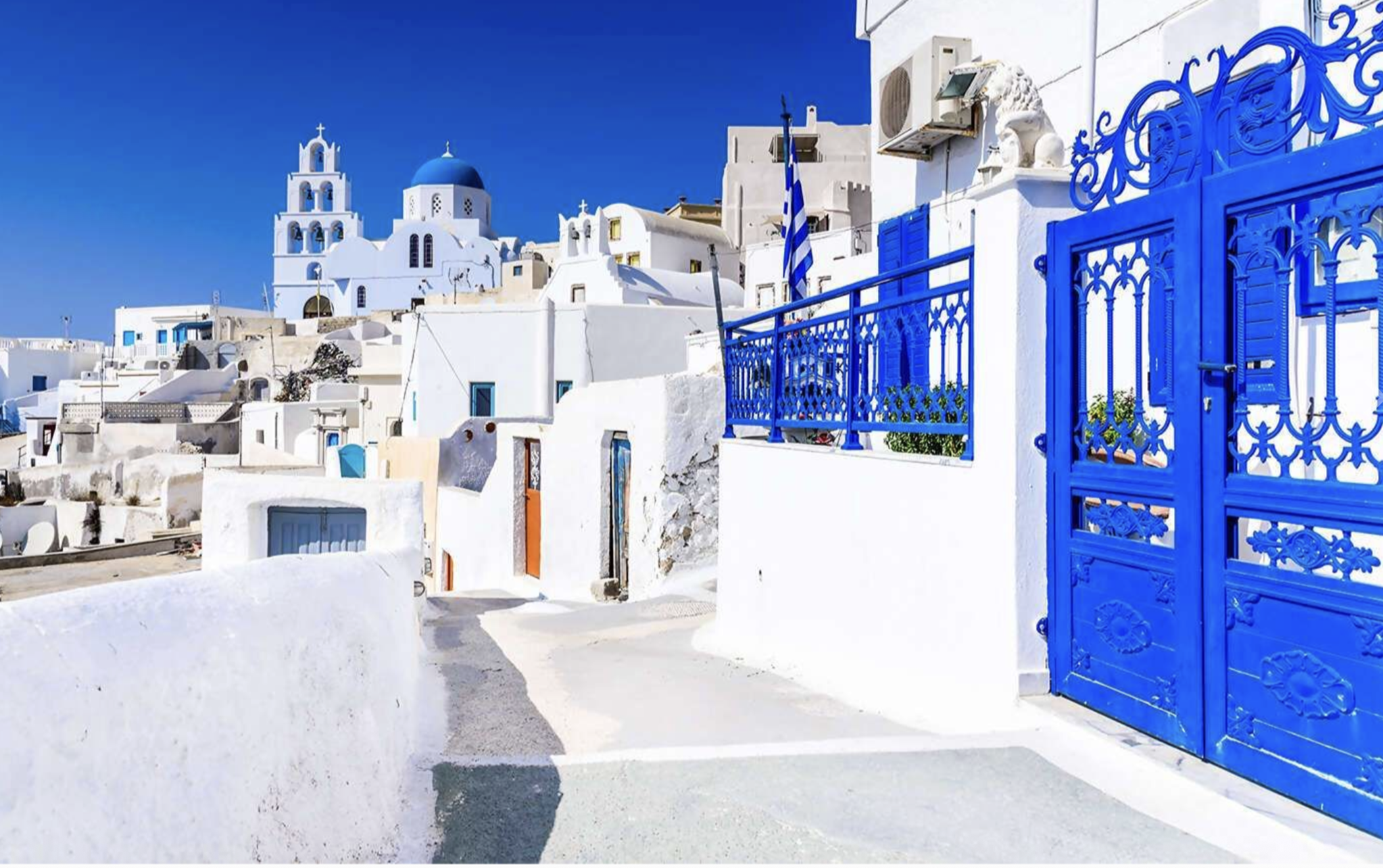Blue and white buildings of Santorini on Studio ONe Yoga & Fit4travel Retreats