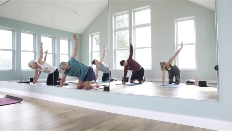 Yogis practicing in a sunshine lit room at White bear lake Studio One Yoga