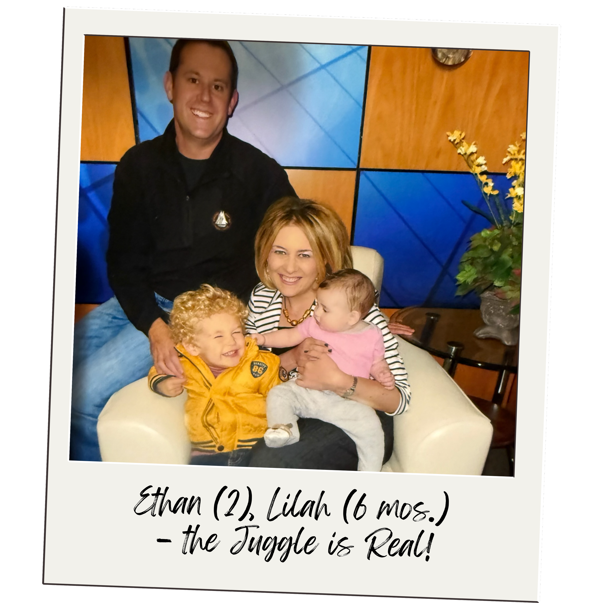 A family photo with a man, woman, and two children sitting on a cream-colored armchair in front of a colorful background. The woman is holding a baby girl, and a young boy with curly hair is sitting beside her, smiling. The caption reads: Ethan (2), Lilah (6 mos.) - the Juggle is Real!