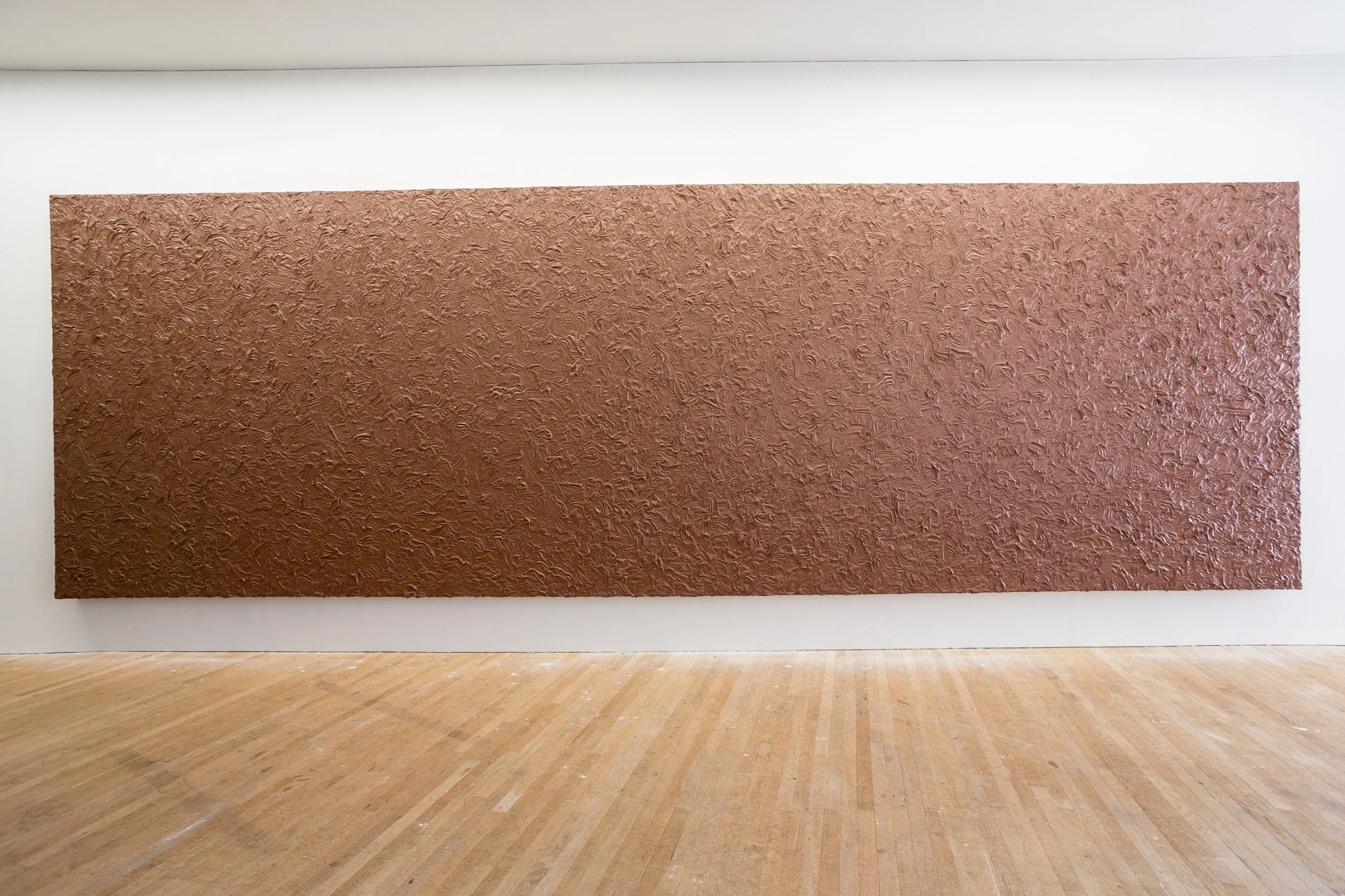 Large abstract textured painting in chocolate displayed on a gallery wall.