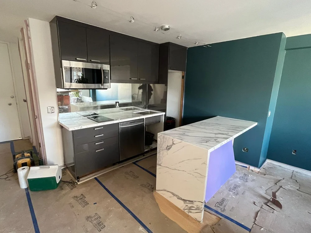 Kitchen during installation with the marble waterfall island