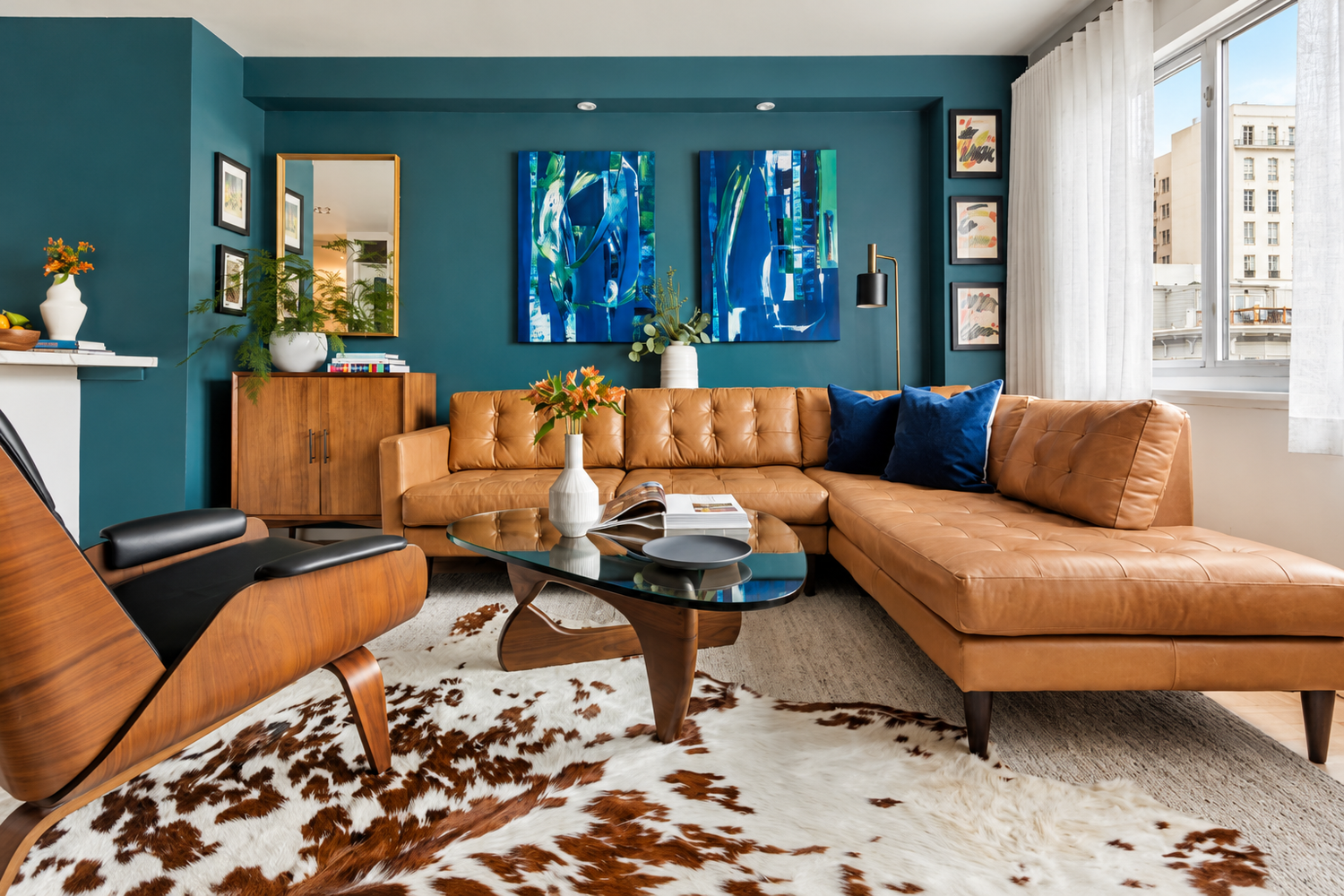 San Francisco condo living room with deep teal walls and a cognac leather sectional