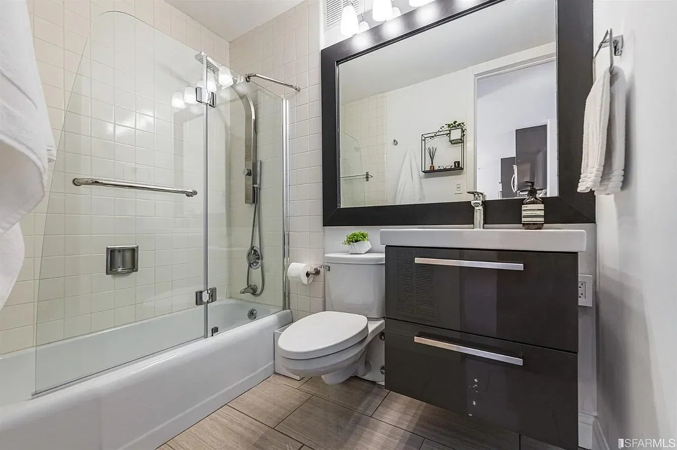Bathroom before the renovation, with the original tub and vanity