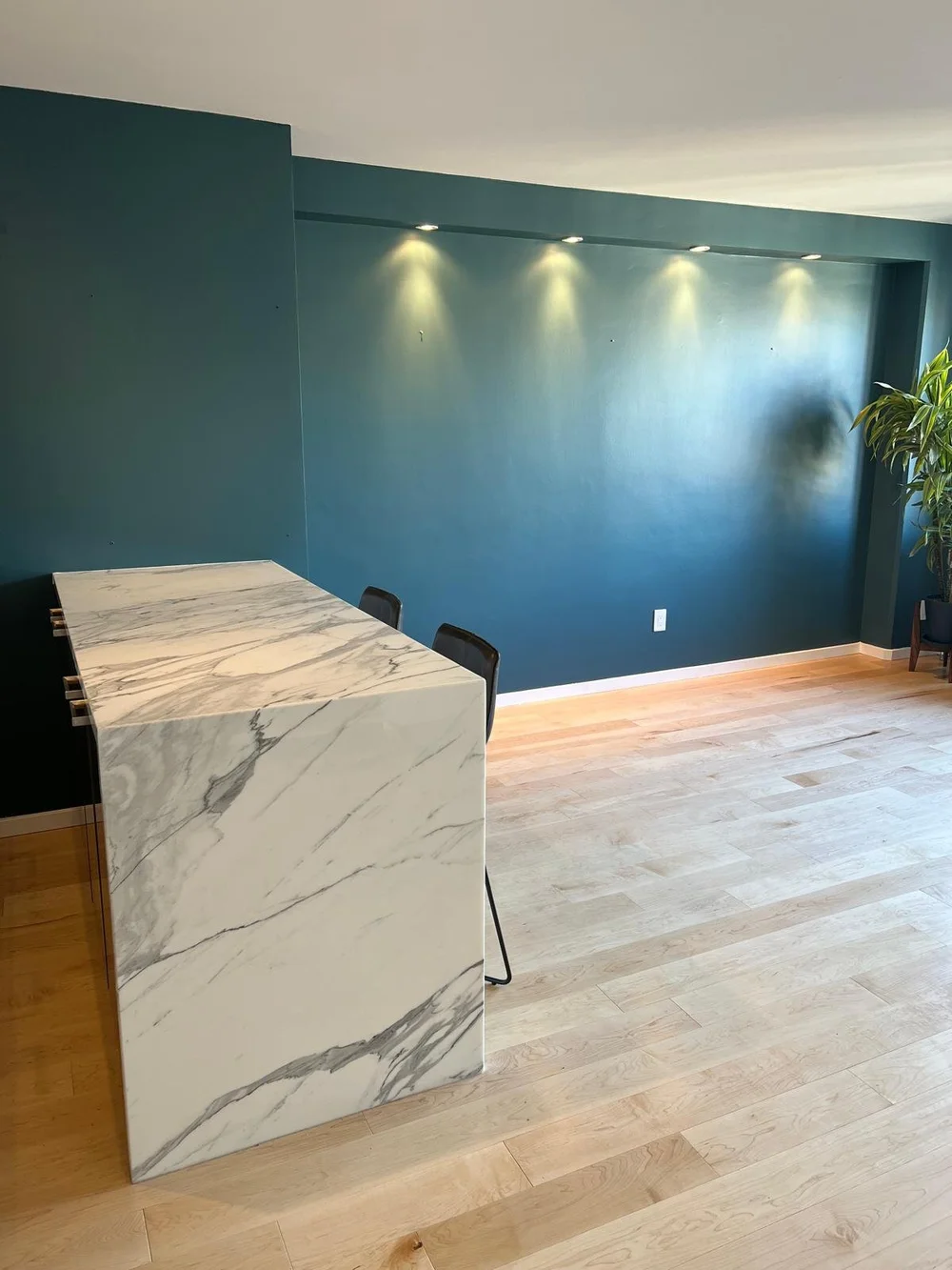 Teal feature wall and marble island before furnishing