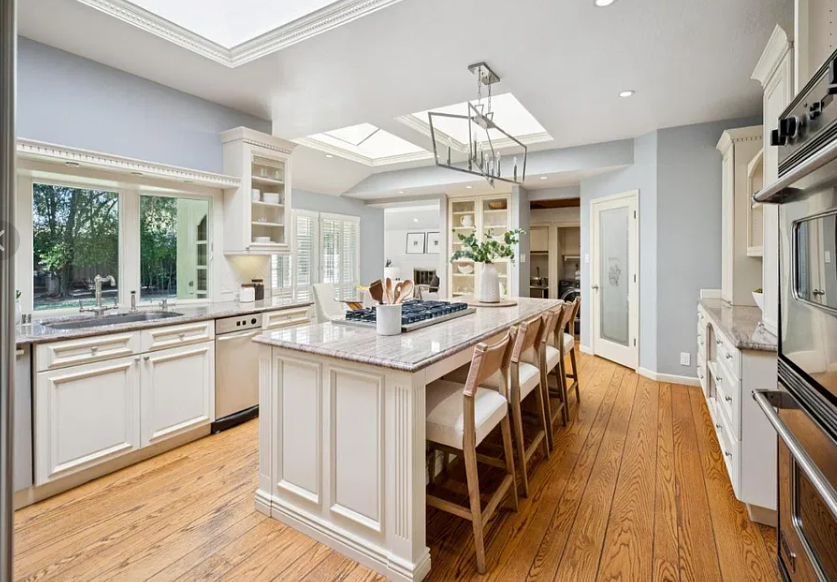 Atherton kitchen before: cream cabinetry, granite counters and skylights