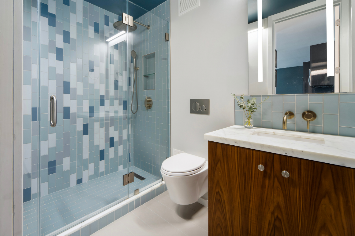 Bathroom after: tiled walk-in shower, wall-hung toilet and walnut vanity with marble top