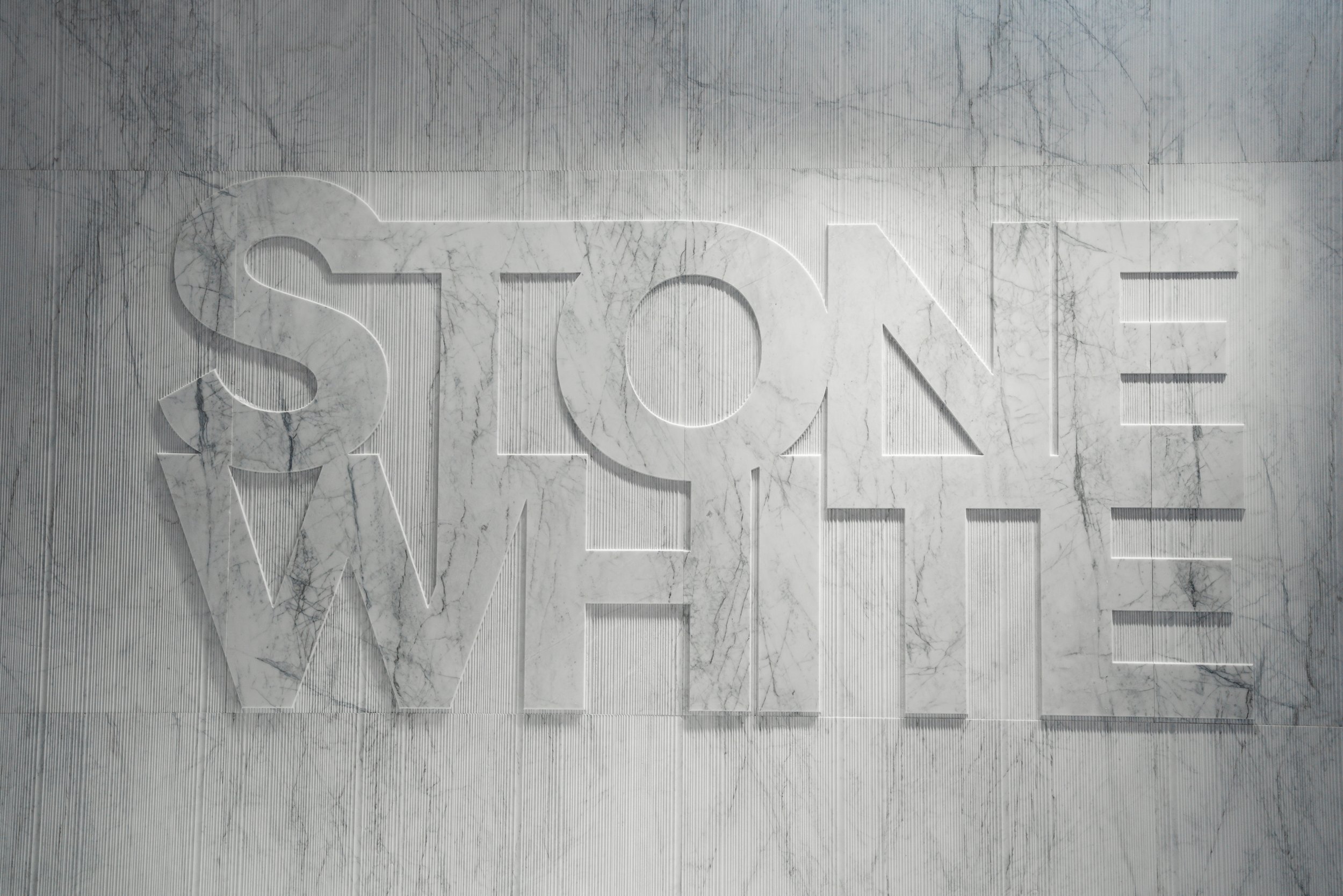Marble wall with the word 'STONE' carved into it.