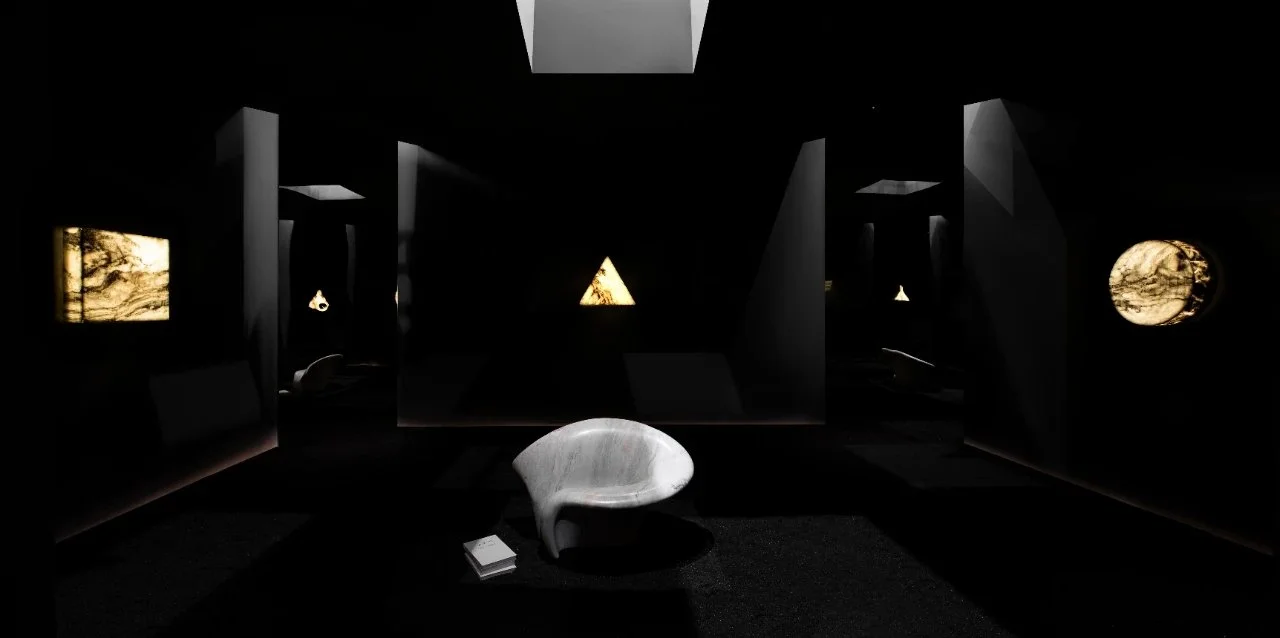 Dark art gallery with illuminated abstract paintings on the walls and modern seating in the center.