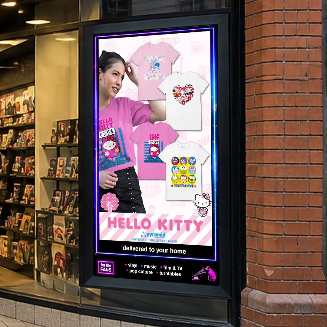 Digital advertisement for Hello Kitty merchandise featuring a young woman and images of various T-shirts with Hello Kitty designs, promotional text, and a list of product categories such as vinyl, music, film, TV, pop culture, and turntables.