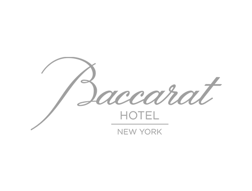 Black background with silver cursive text reading "Baccarat Hotel New York."