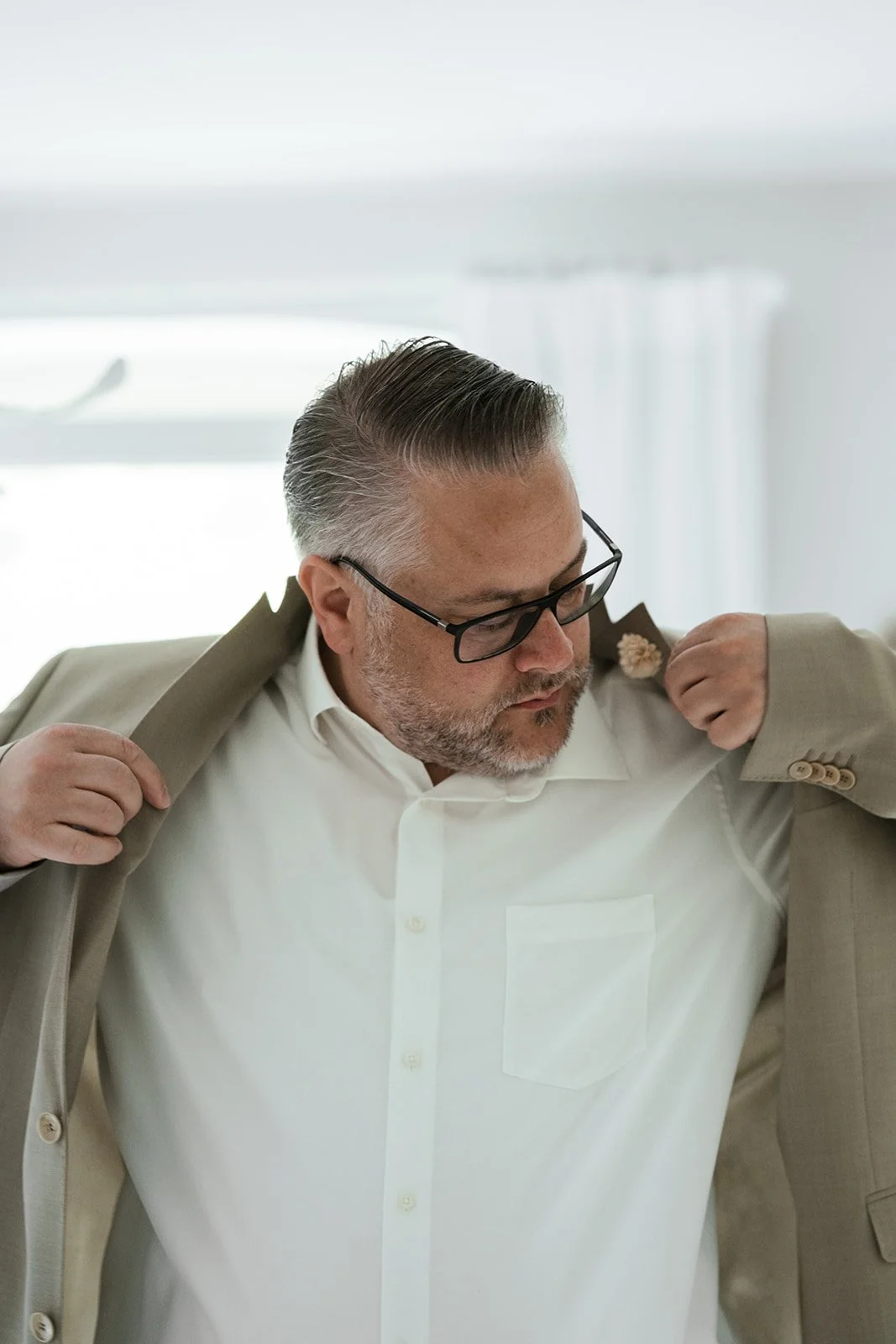 Bräutigam im beigen Outfit macht sich fertig