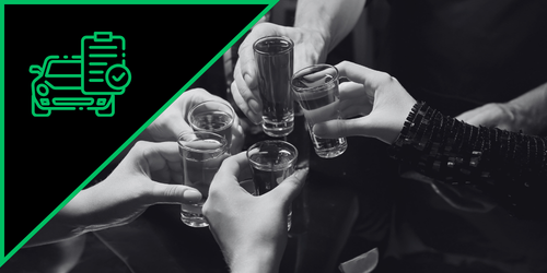 Group of people clinking shot glasses in a toast