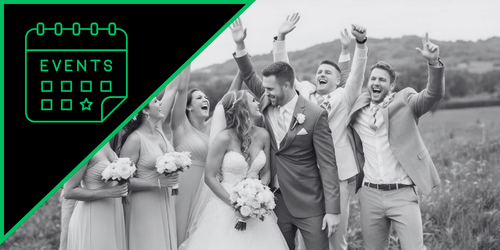 Group of people celebrating outdoors, with a bride and groom at the center, surrounded by friends, all in formal attire.