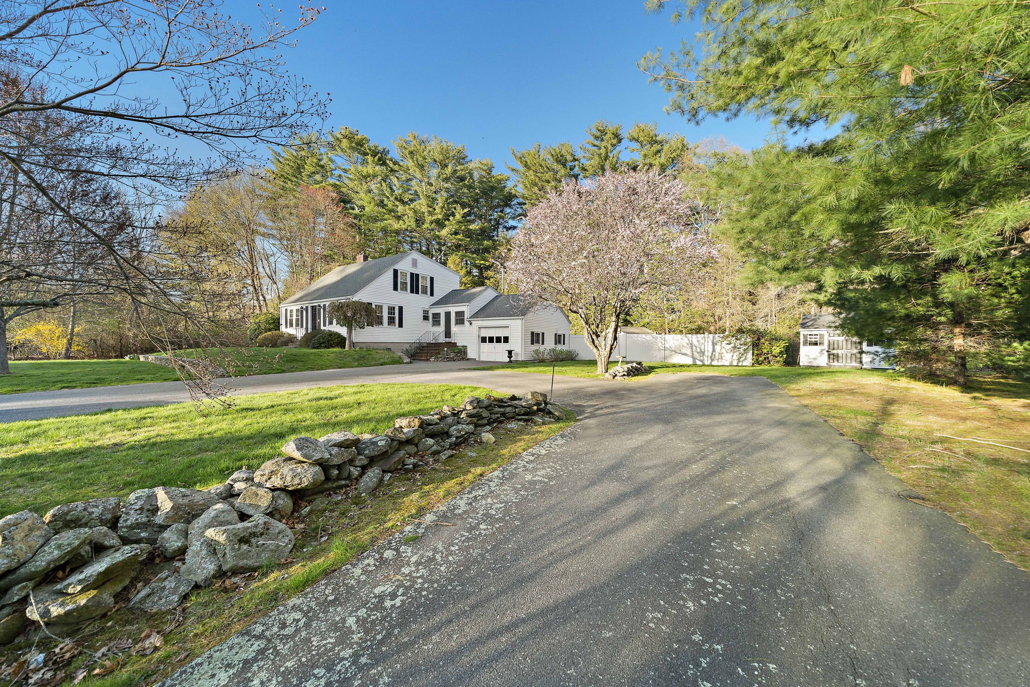Front view of home with circular driveway at 63 Reed Street Hanson MA