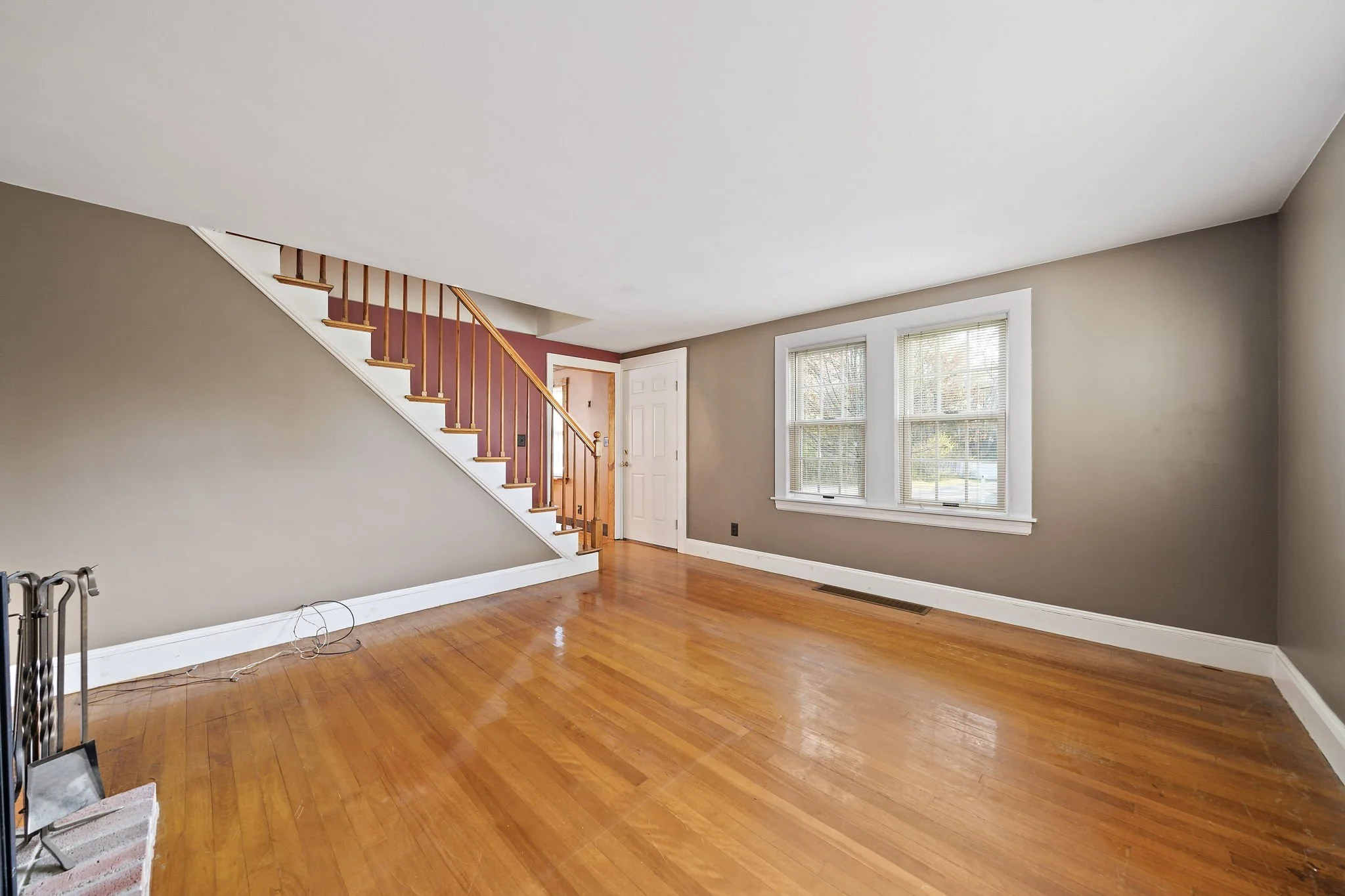 Living room with view of staircase showing home layout at Hanson MA home