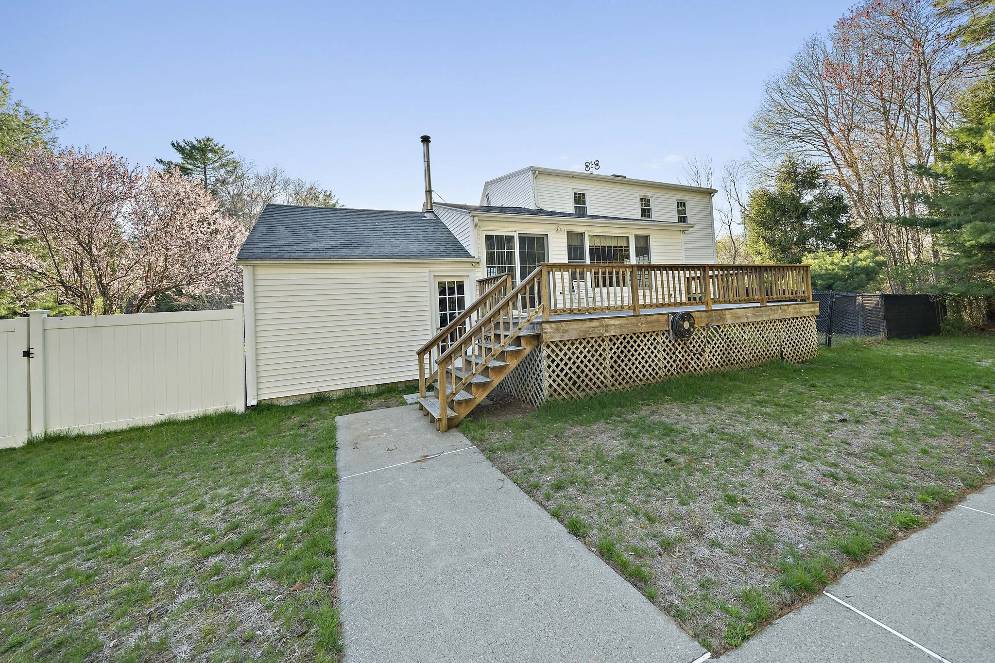 Rear exterior of 63 Reed Street Hanson MA home with backyard