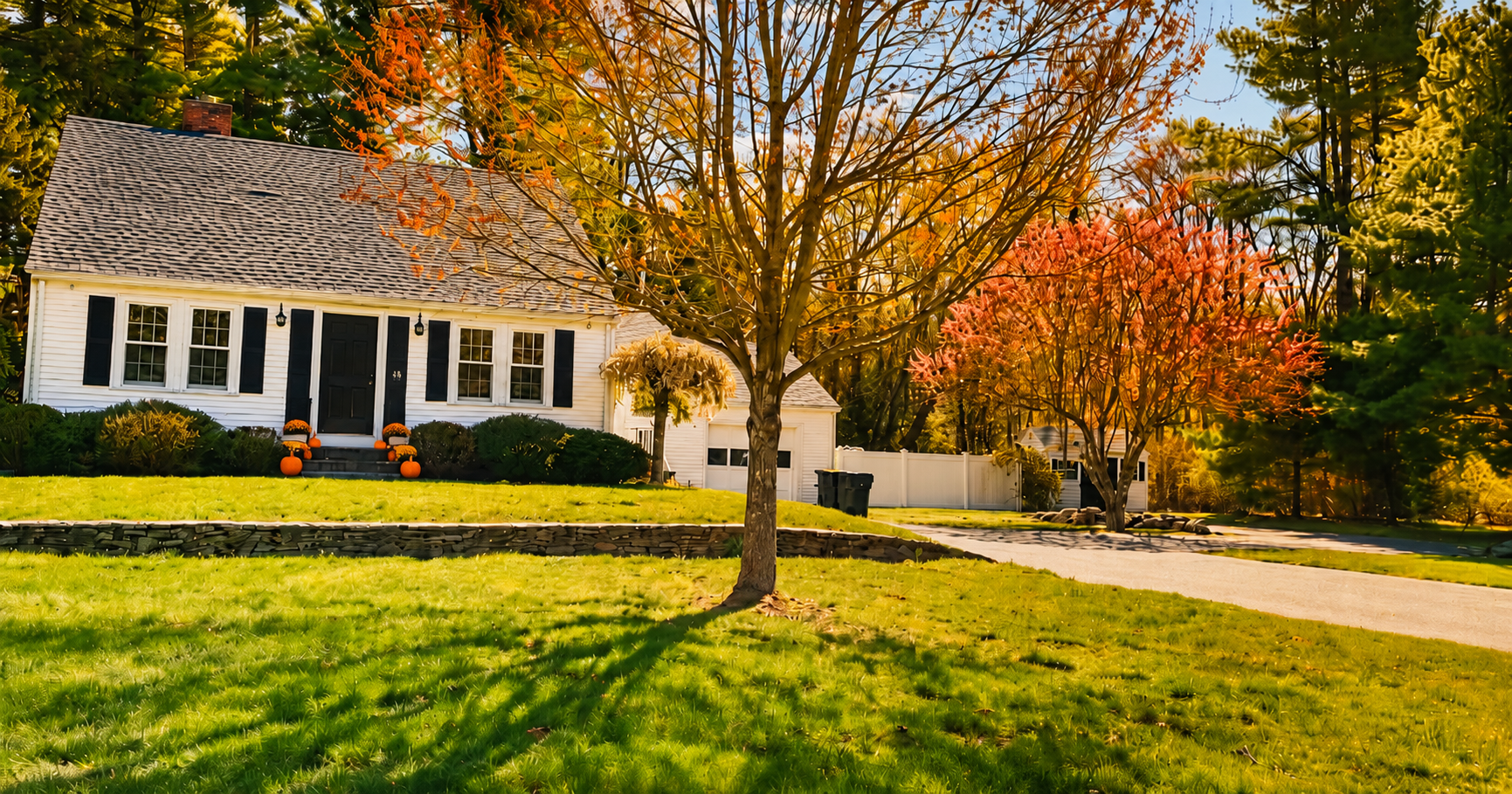 Single-family home in Hanson, MA in Plymouth County featuring a fall decorated front porch with pumpkins.