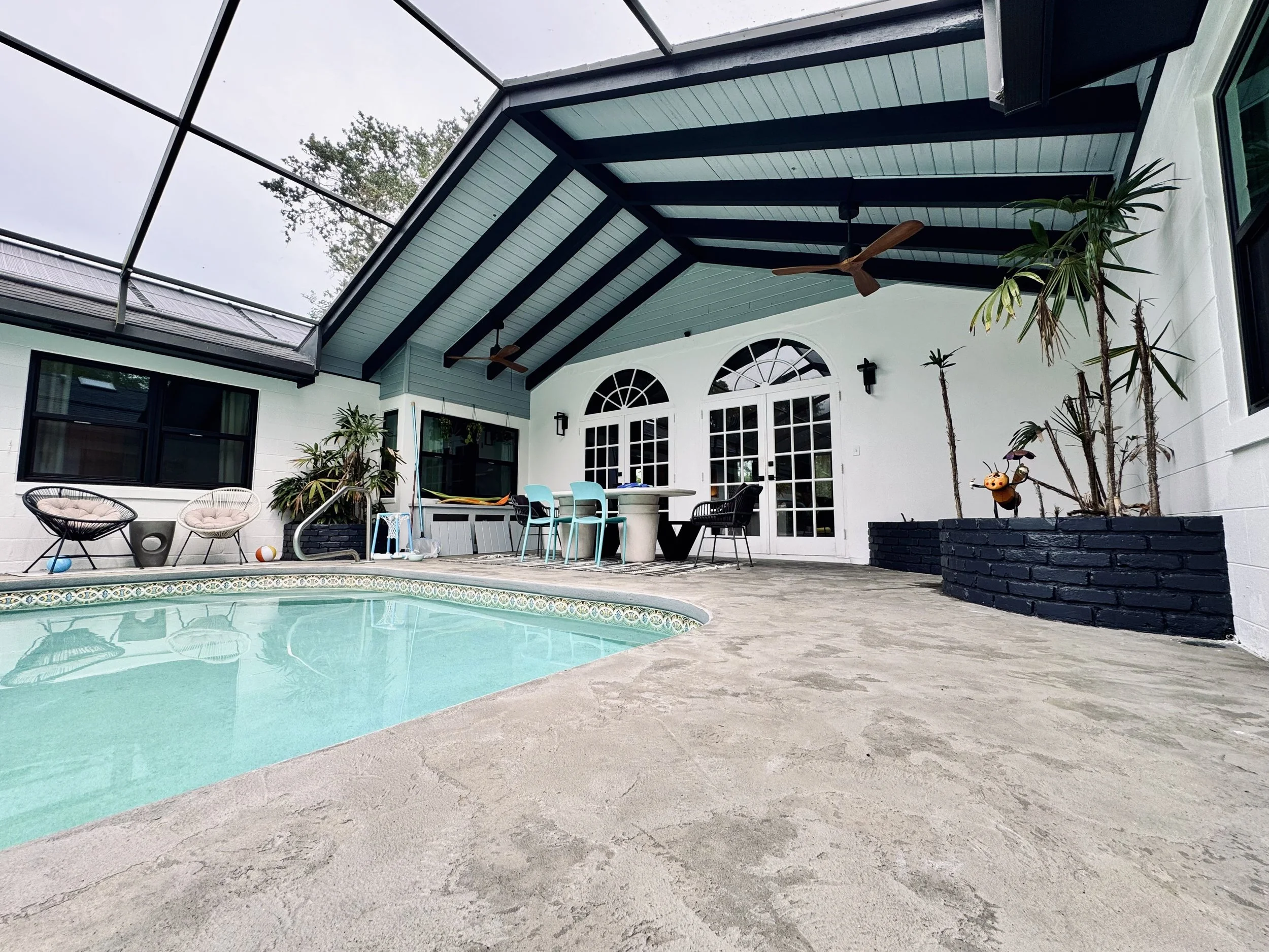 Complete patio renovations and exterior painting, custom painted brick flower beds we did in an Ormond Beach Florida Home.