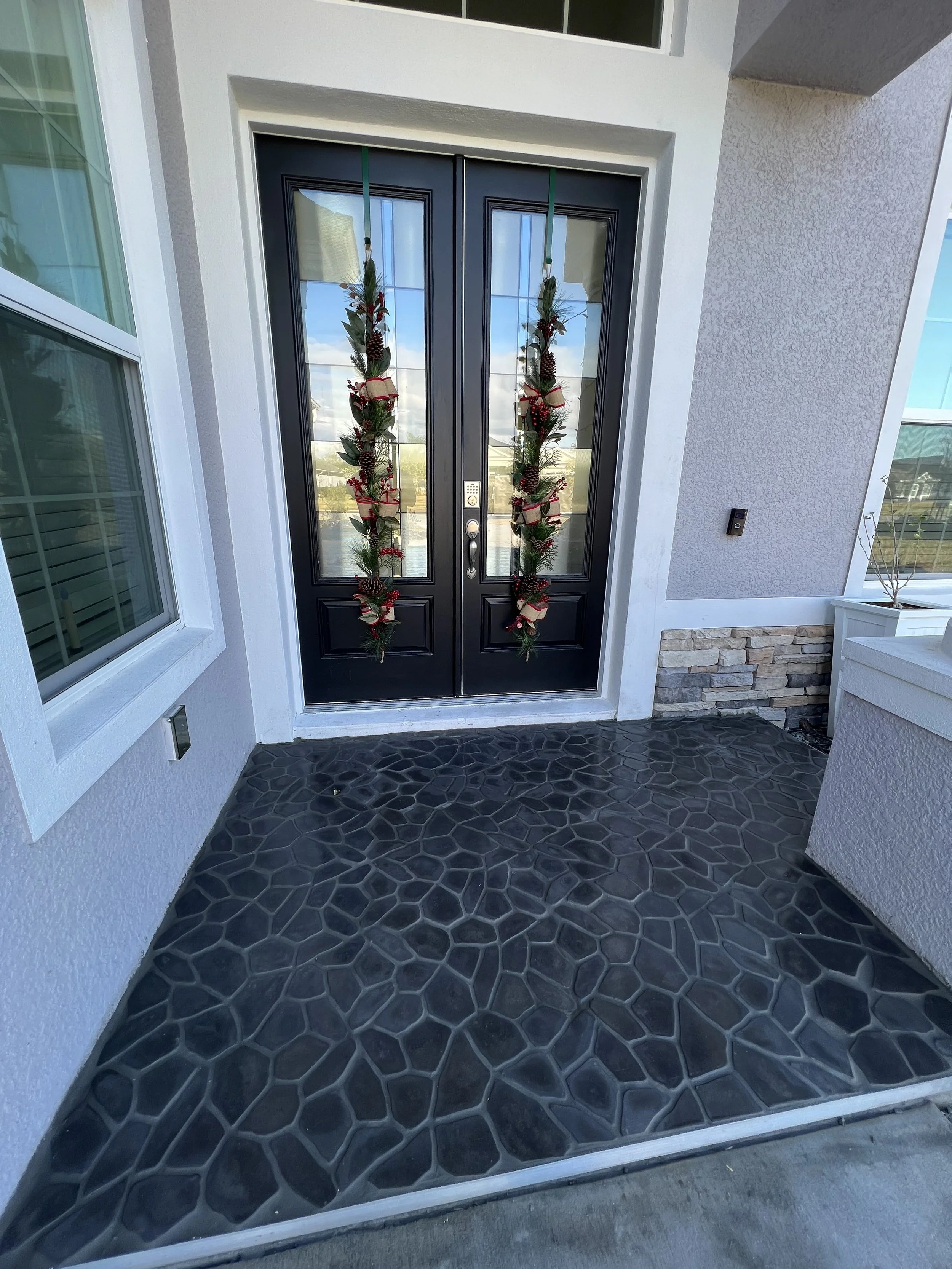 Custom entryway with cobblestone installed in 2023 in Ormond Beach Florida Home. We sealed the stone for long lasting finish. 