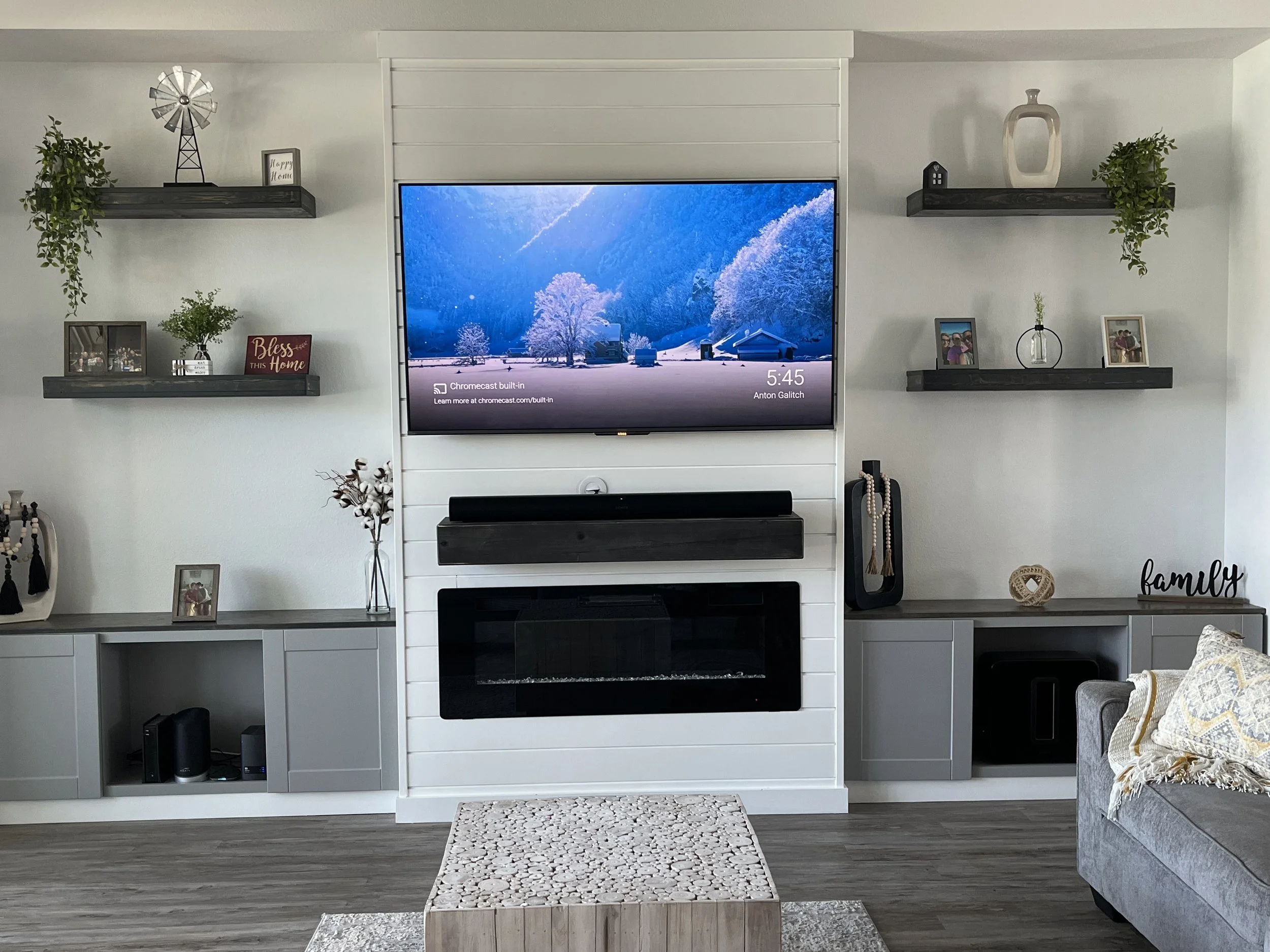 Custom built and designed by us in 2022 for a living room built in and custom paint job utilizing cabinet painting and tv mounted flush with unit, custom floating shelves, cabinets installed, gives a nice rich elegant feel for this Ormond Beach Home