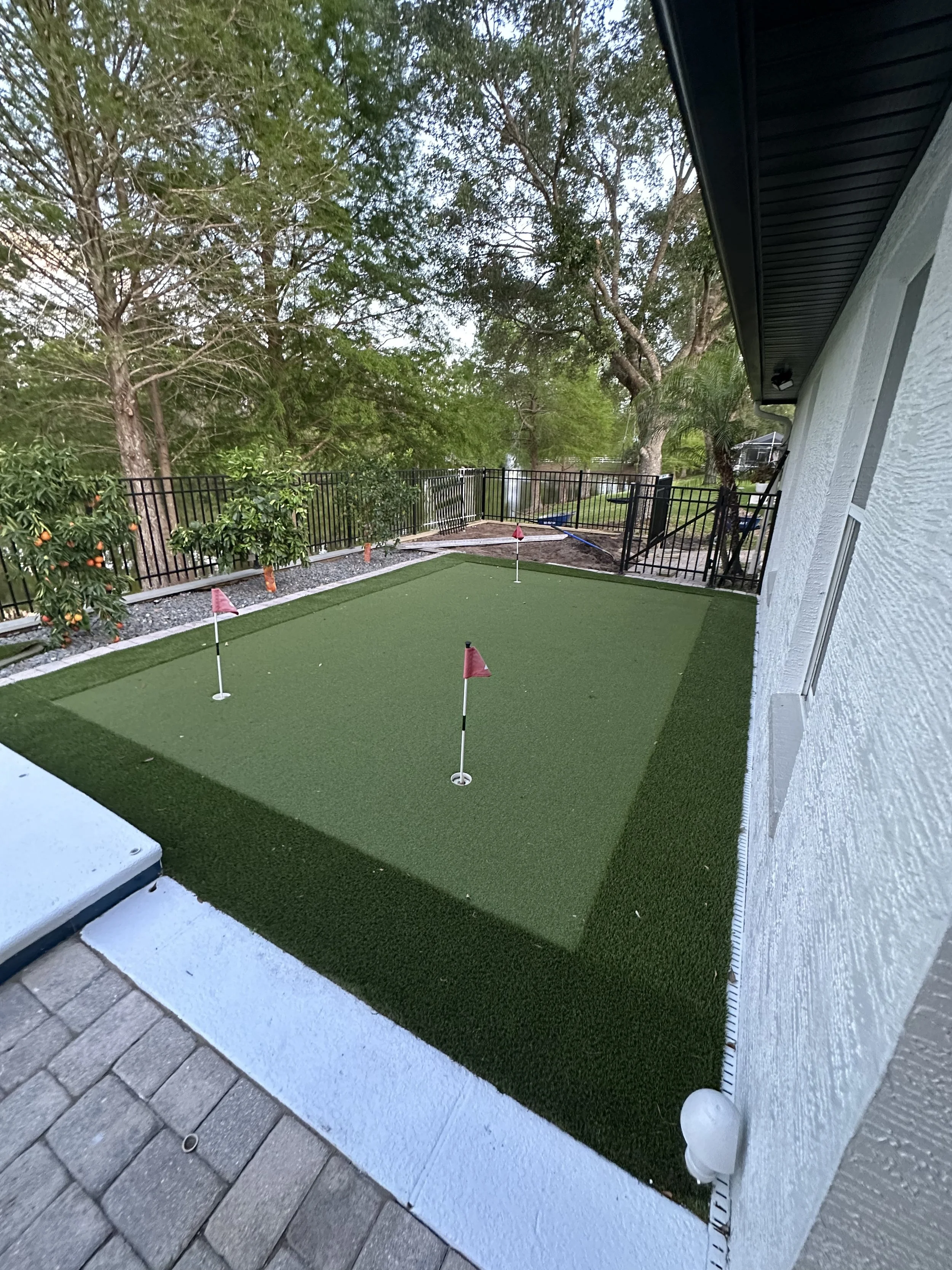 Custom built artificial turf installation with putting green and landscape and hardscape feature. Landscape lighting installed to illumite with beautiful LED for nighttime use. We completed this project in ormond beach florida in 2024