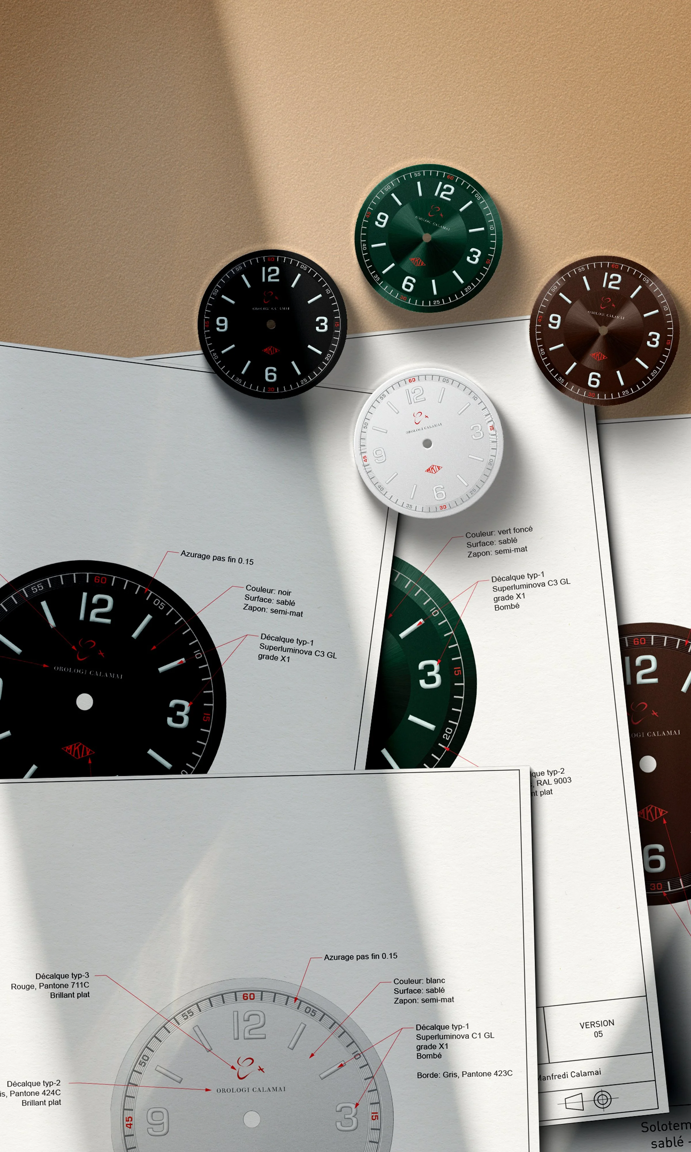 Various watch faces and designs displayed on sheets of paper, featuring different colors, styles, and markings.