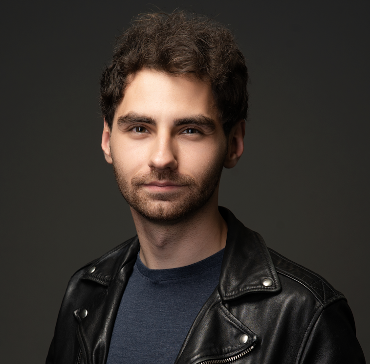 Image of Alan wearing a black leather jacket and navy blue shirt