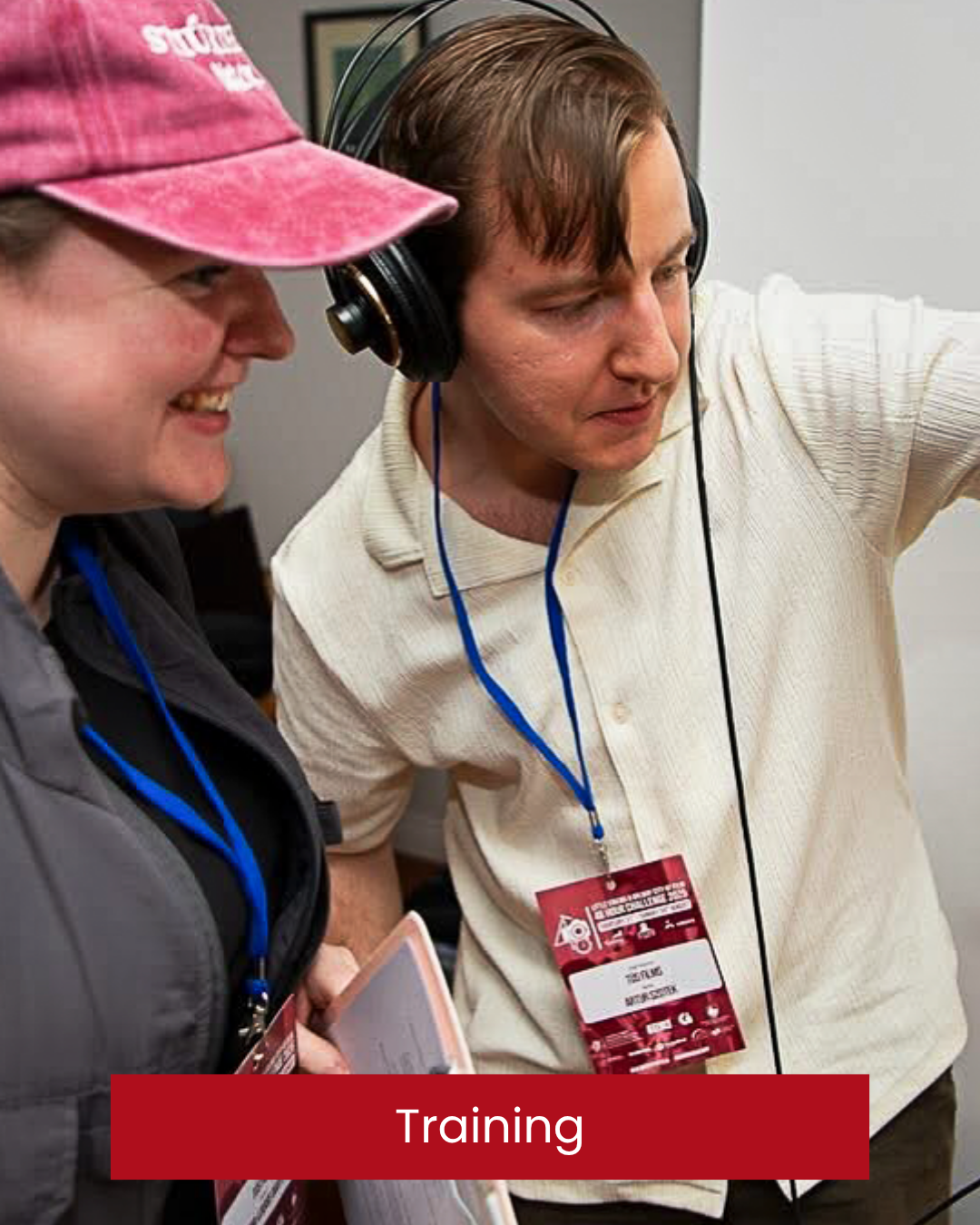 Two people involved in a training session; one person wears headphones and appears to be listening, the other person is pointing or demonstrating something. Galway, 48 hours Little Cinema. Donegal Filmmaking Workshop. Donegal Video Training.