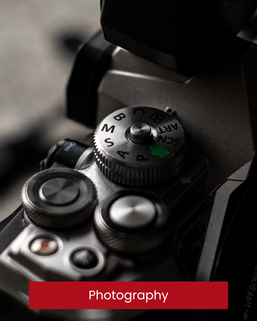 Close-up of a camera's control dials and buttons, showing various shooting modes and settings. Olympus camera, black and white photography. Wedding photographer. Wedding videographer. Wedding Filmmaker Donegal.