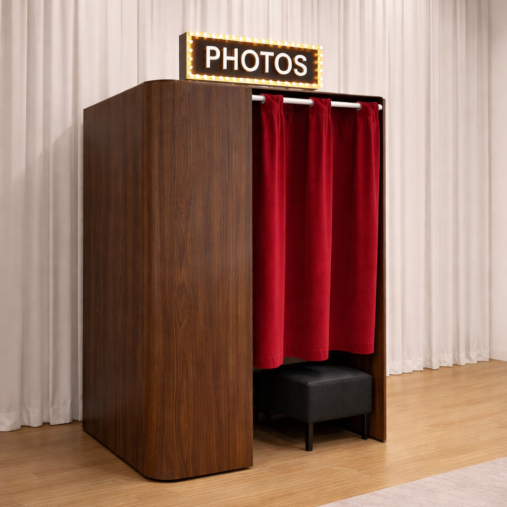 Vintage style, enclosed photo booth in walnut brown exterior with red velvet curtain. Available for rent in Seattle, Washington.