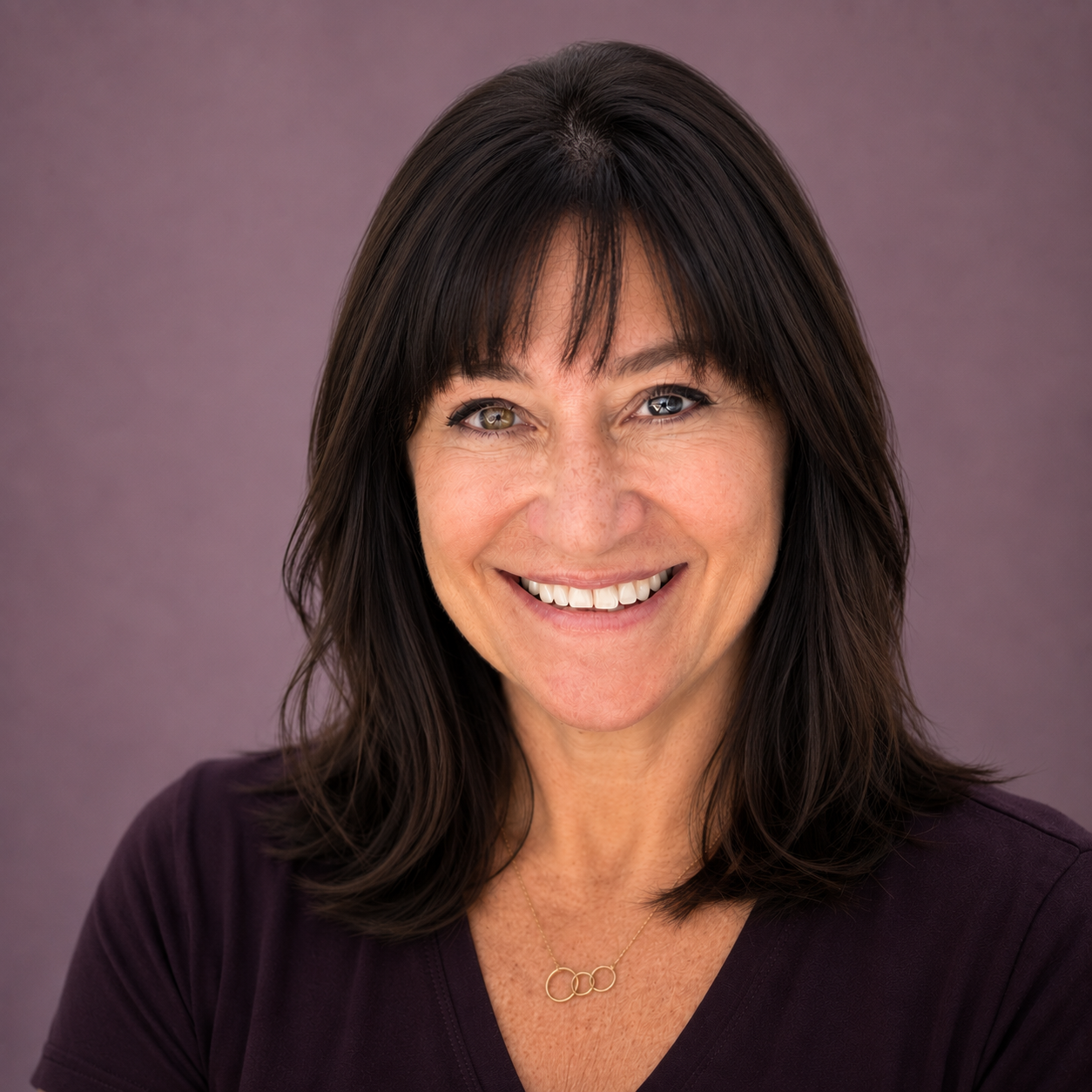 Headshot of Kristine on a purple background