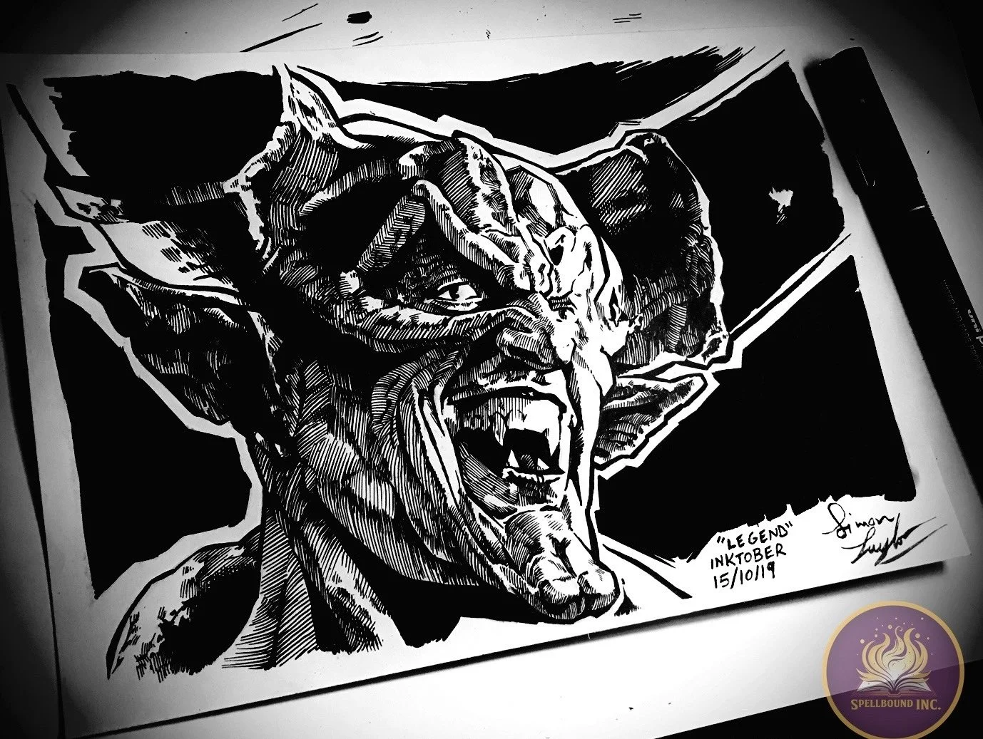 Black and white ink drawing of a dragon with sharp teeth, horns, and fierce expression, signed by the artist and labeled 'Inktober October 15, 2019'.