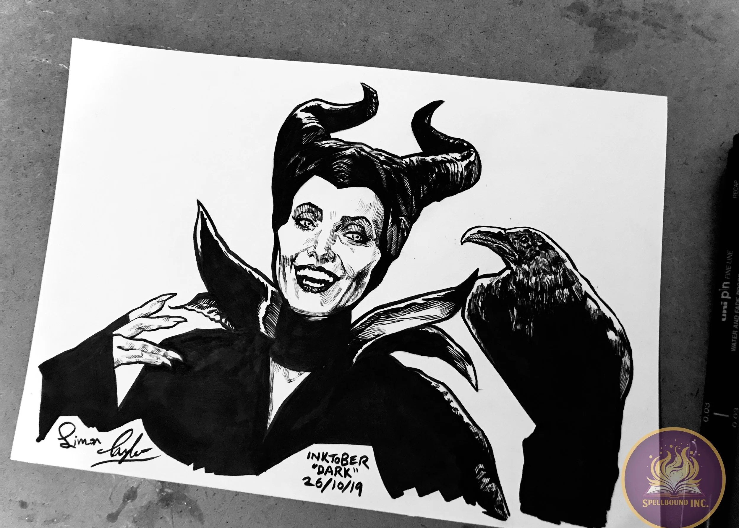 Black and white ink drawing of a woman with horns and a raven on her shoulder, signed by the artist, with text indicating it was created in October 2019.