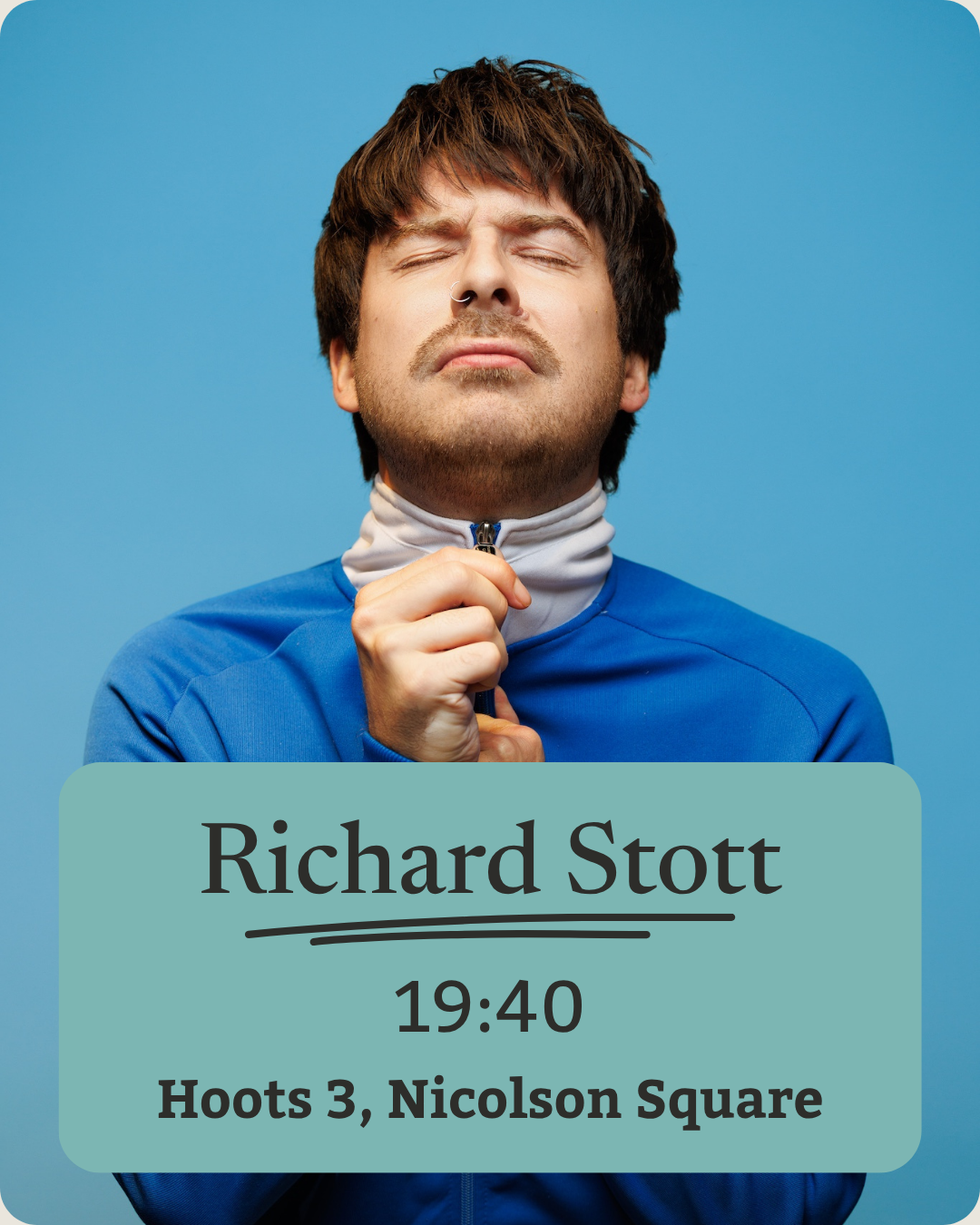 A man with dark hair, closed eyes, and a nose piercing zips up a blue jacket against a blue background.