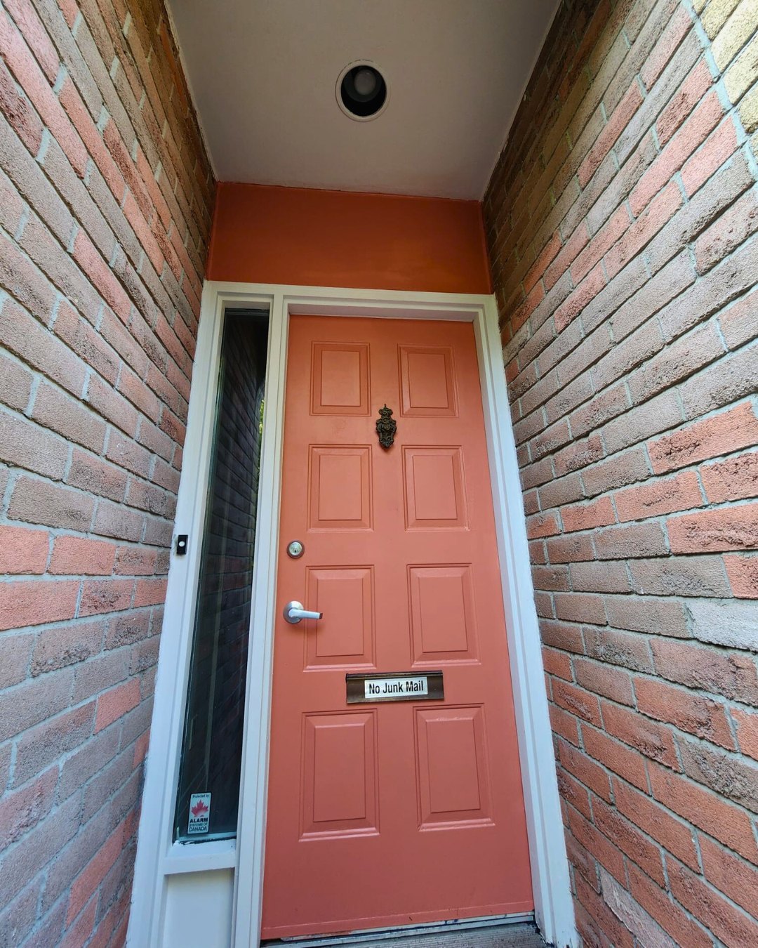 Front door painted red-orange with a