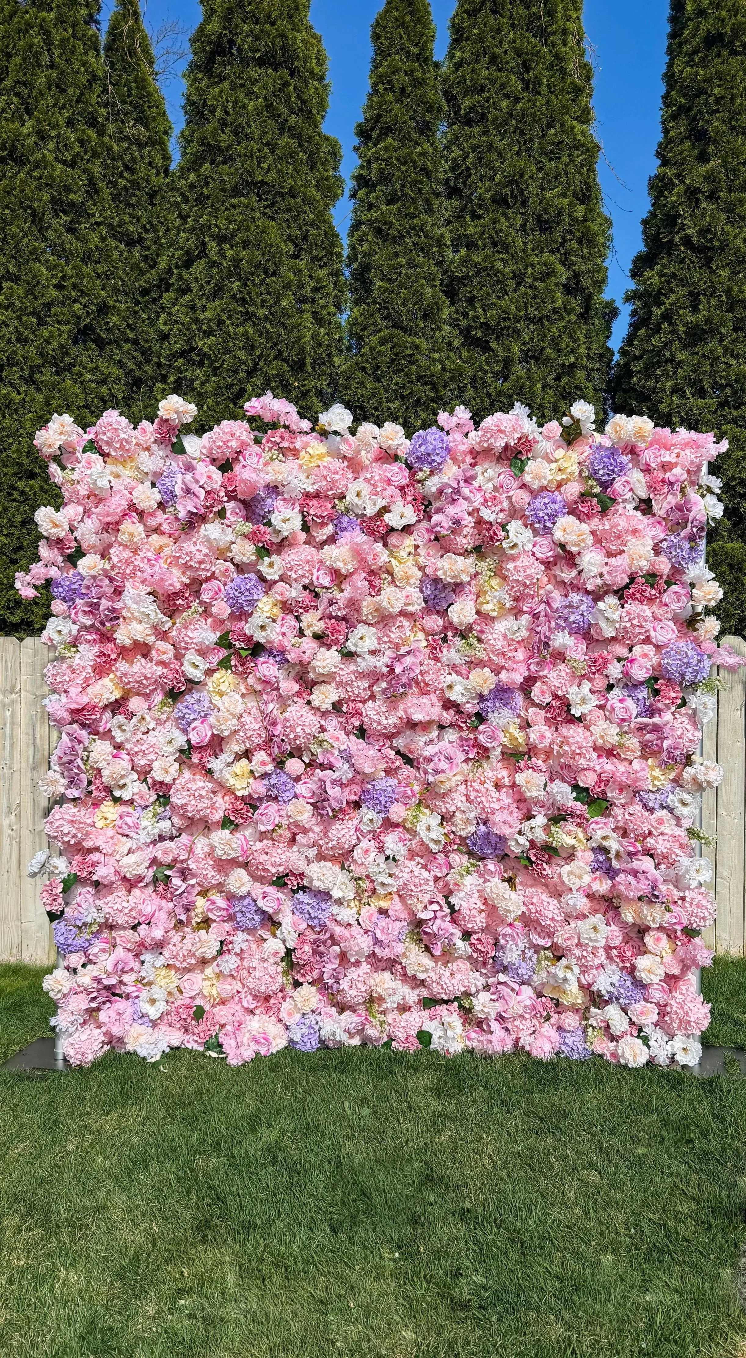 A large flower wall decorated with pink, white, and purple flowers. Saratoga Schenectady Albany Troy